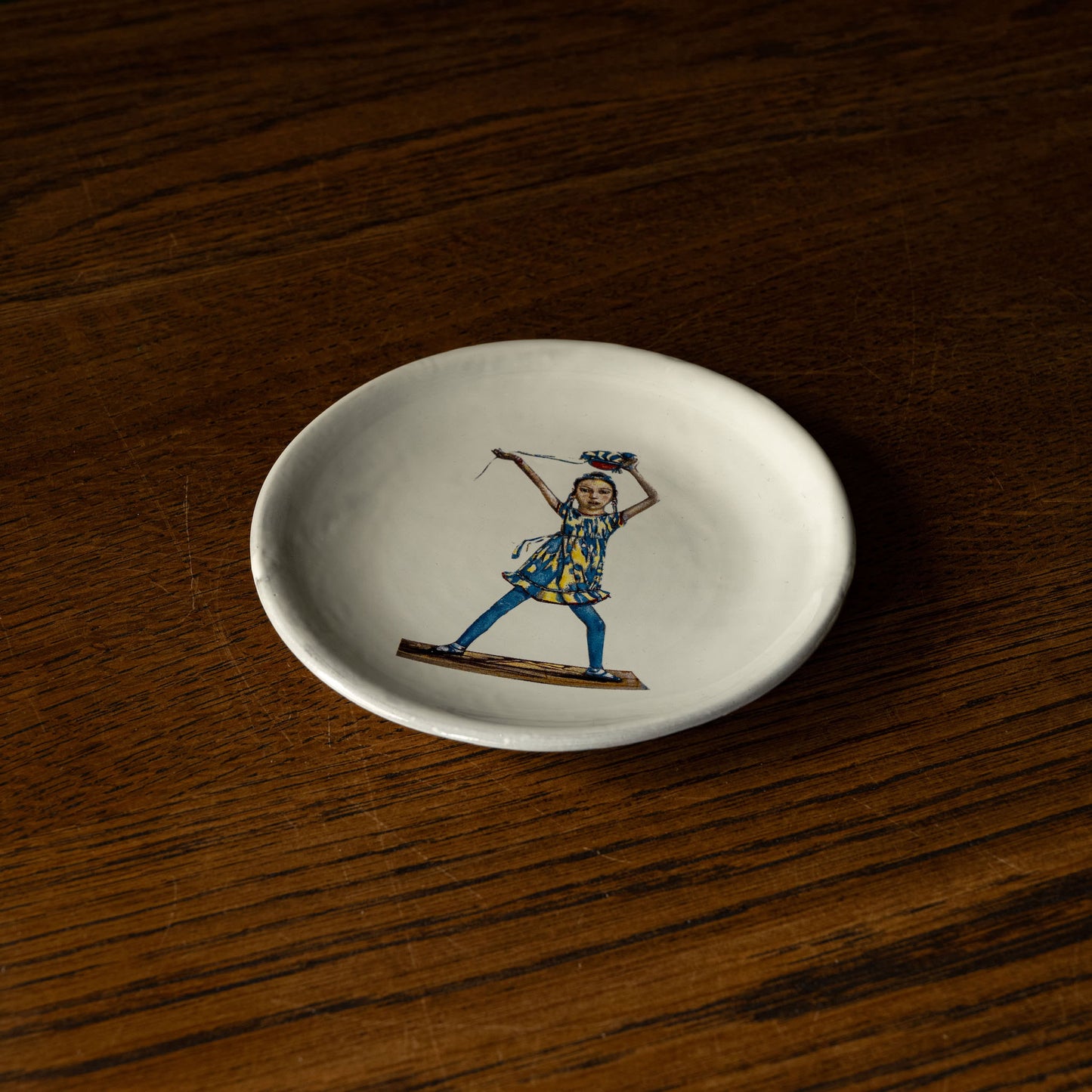 Carron Paris small white plate with a colourful illustration of a dancing woman