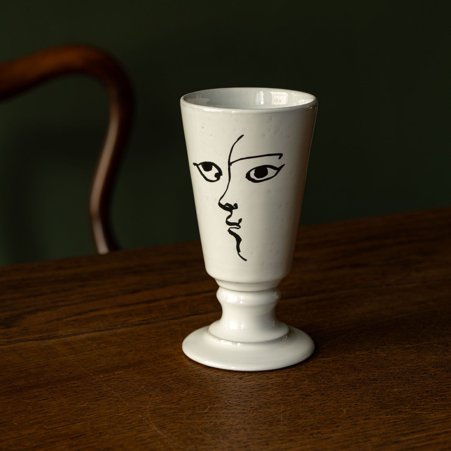 Carron Paris small white footed vase with an abstract illustrated face design