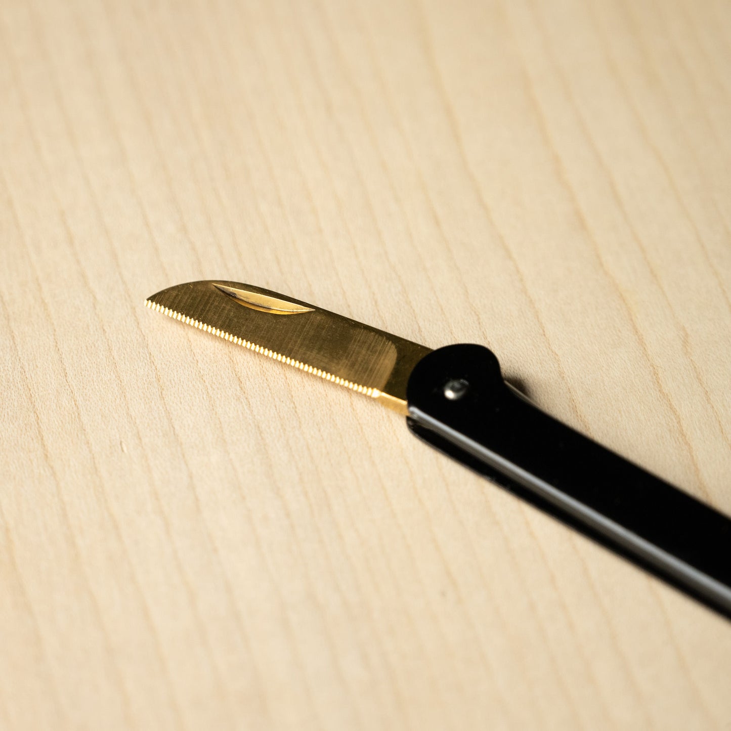 Cartailler Deluc Serrated Blade in Gold.