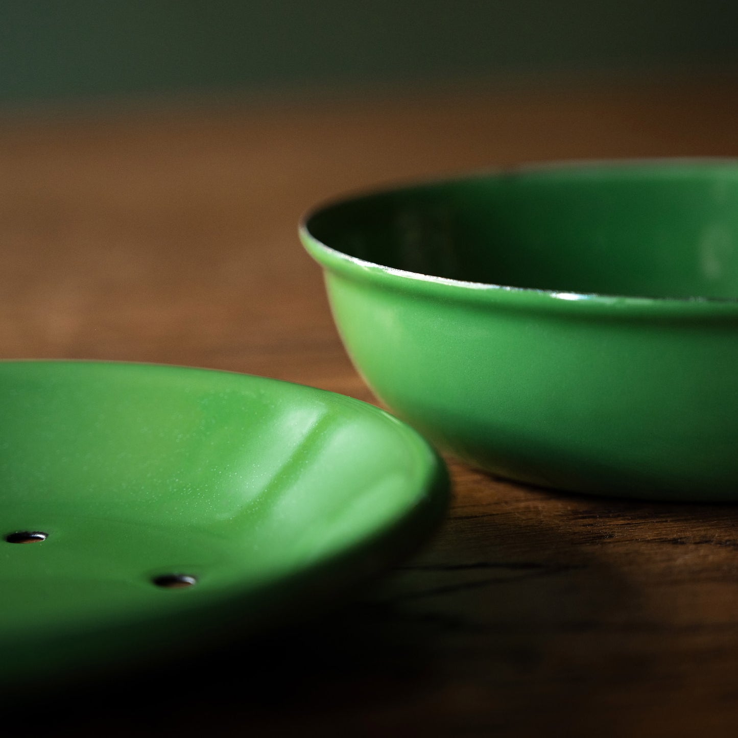 Side view of green enamel soap dish bowl and top