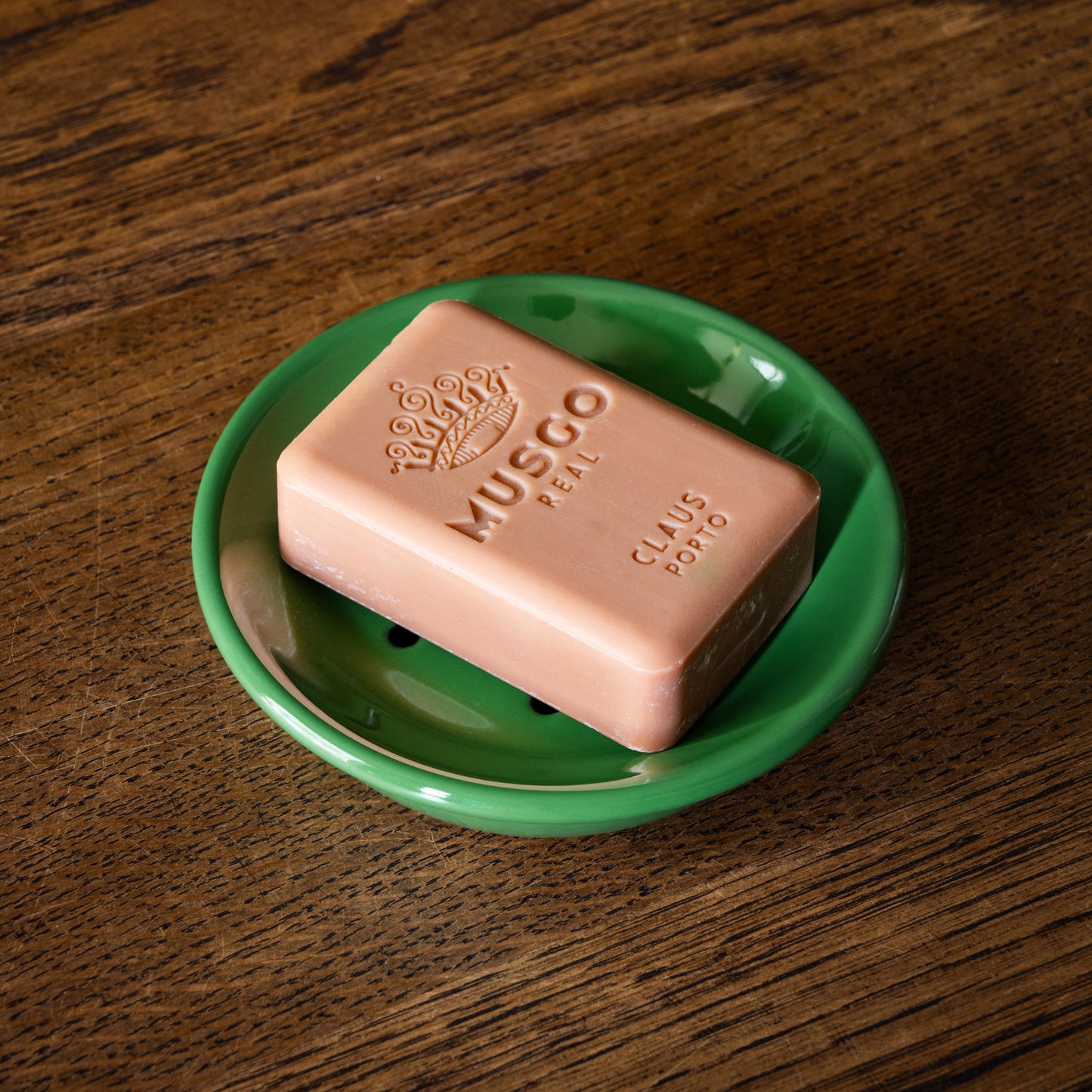 Musgo bar of soap on an enamel green soap dish