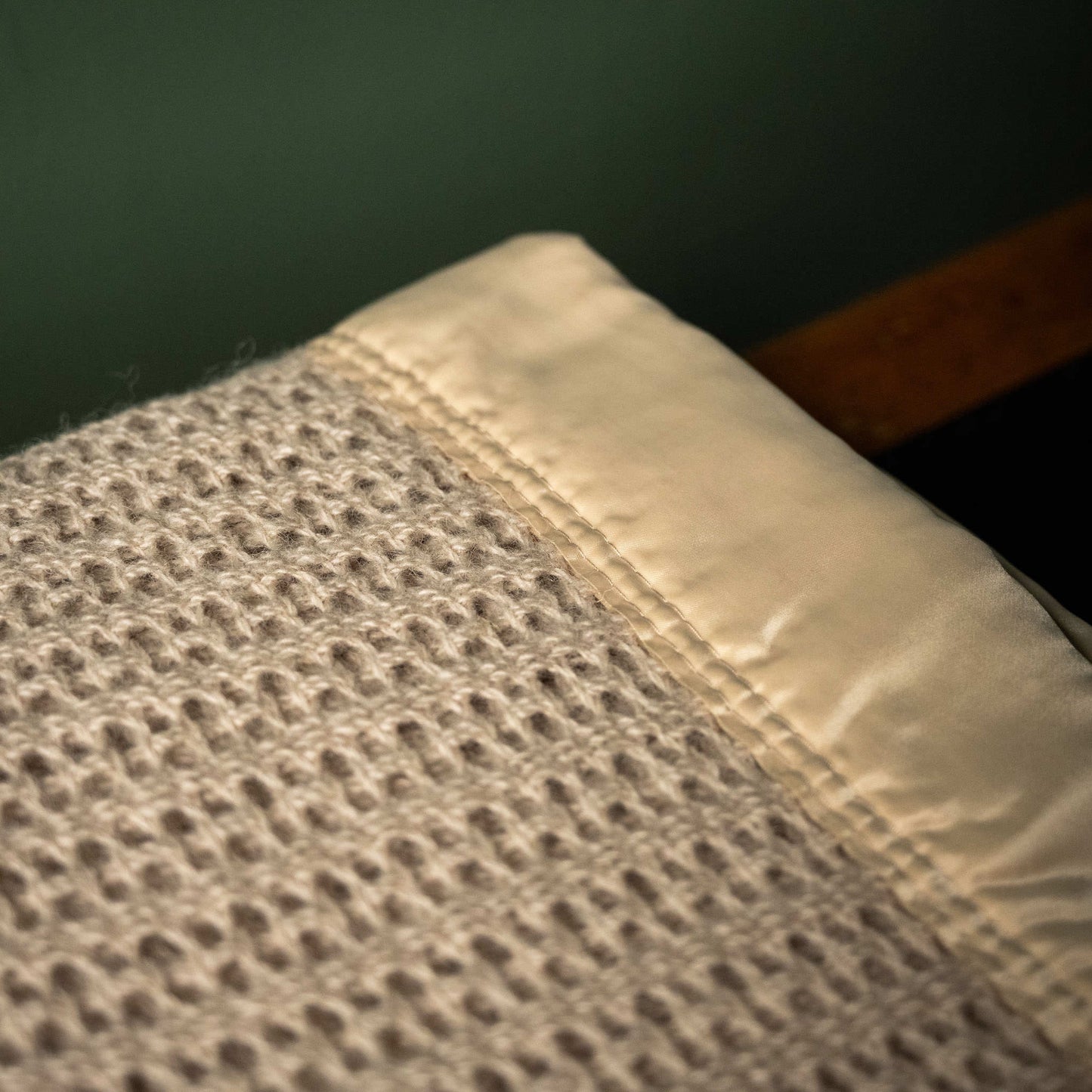 Cellular weave of John Atkinson Atkincel Blanket with satin binding in camel colour.