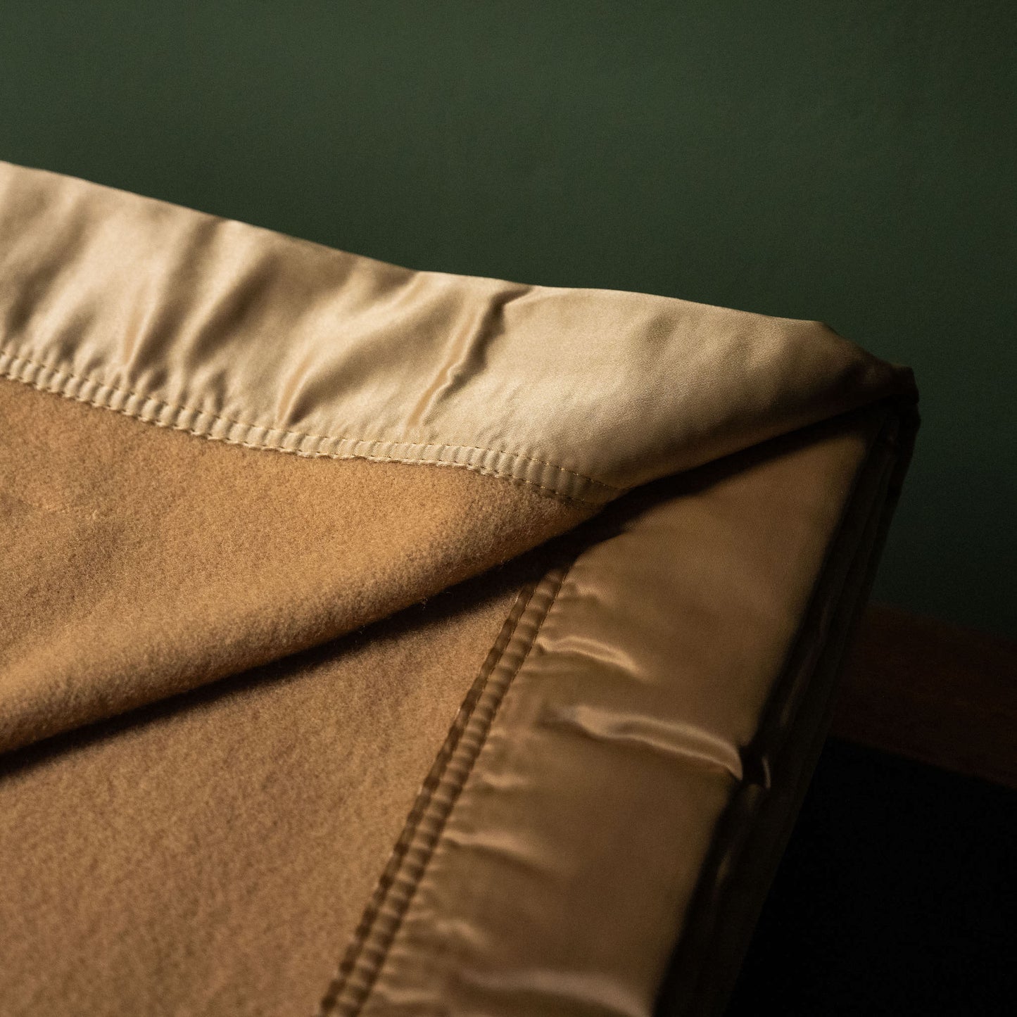 Satin binding of John Atkinson Duchess Merino Wool Blanket in Champagne colour.