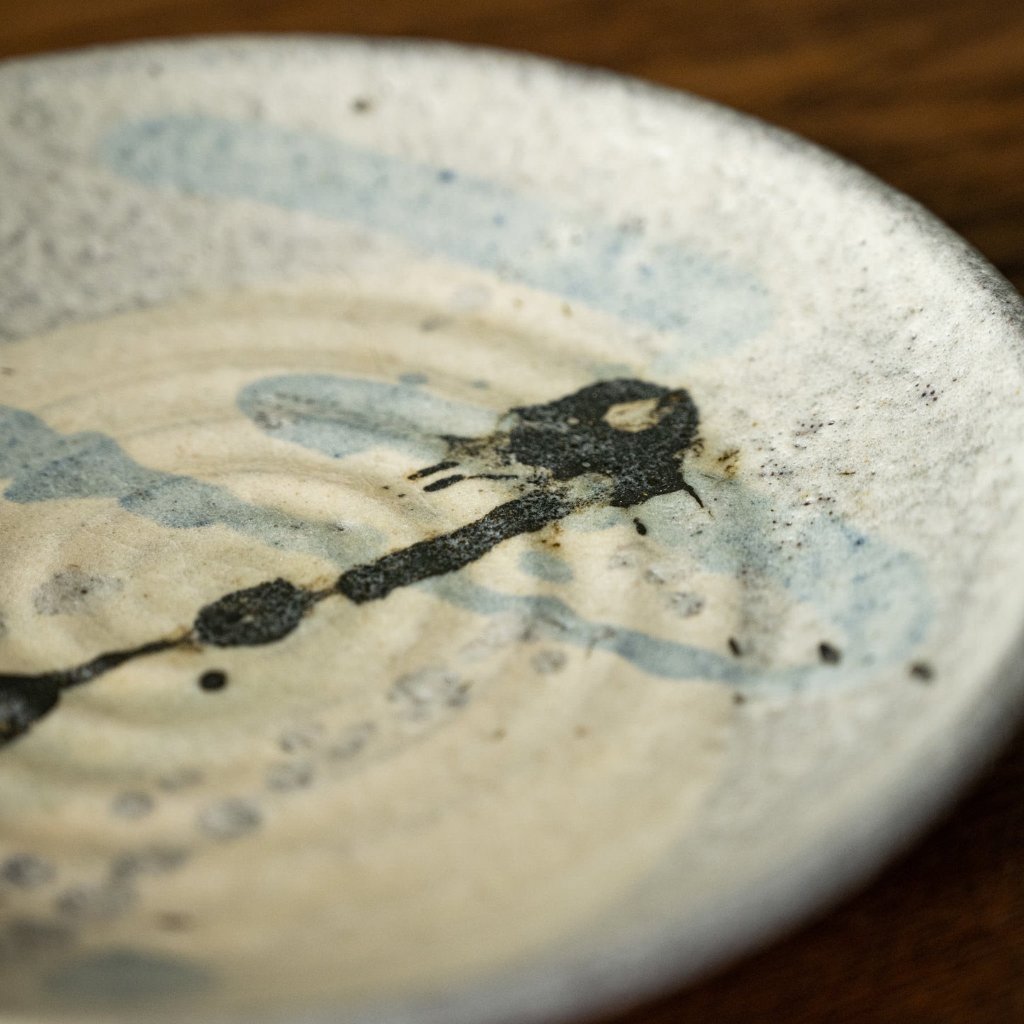 Close-up of Joshua Williams earthenware plate with abstract slip designs