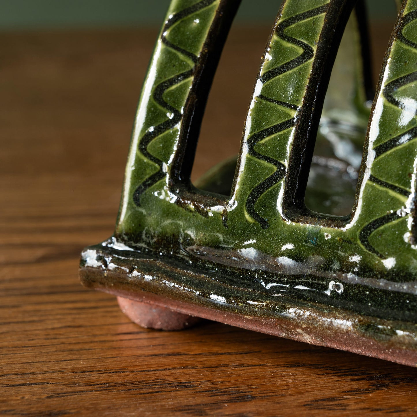 Close-up of glaze & surface design of Joshua Williams green earthenware toast rack