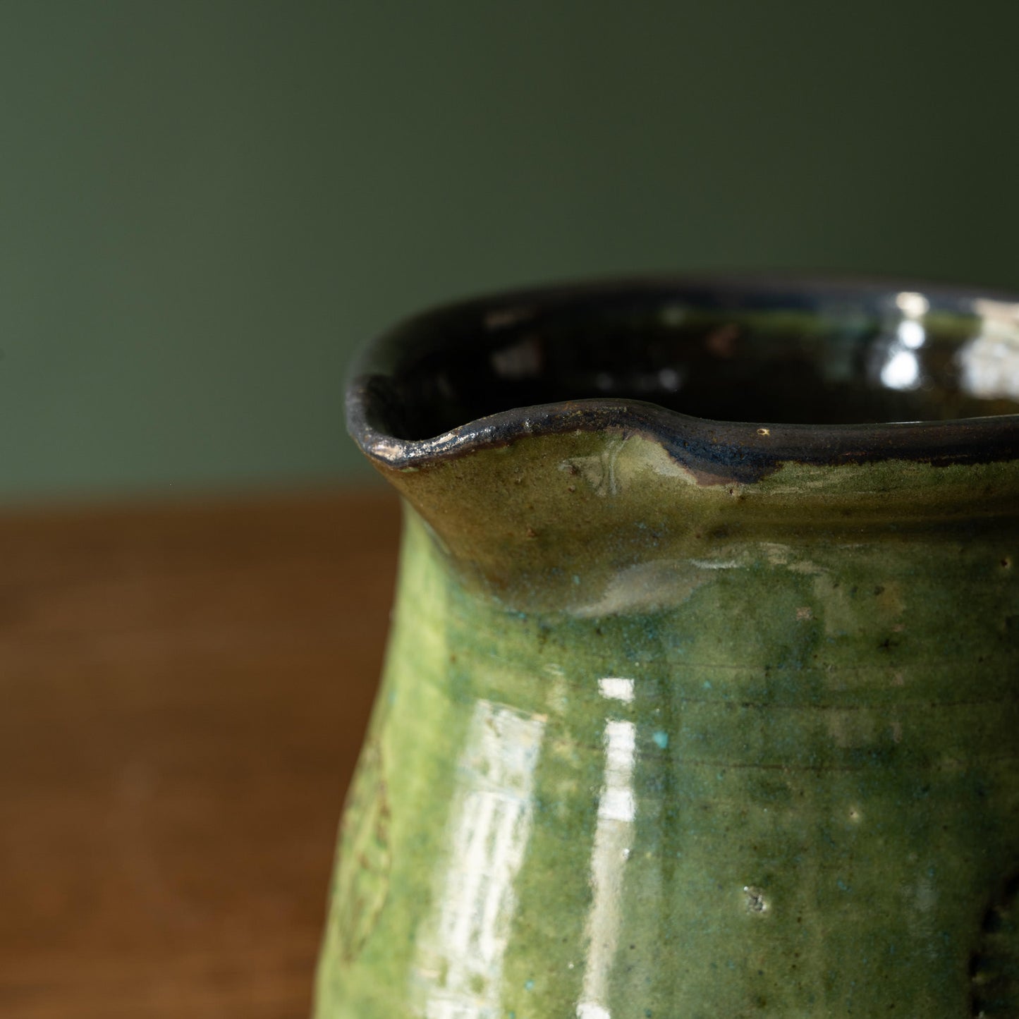 Close-up of Joshua Williams green ceramic jug spout