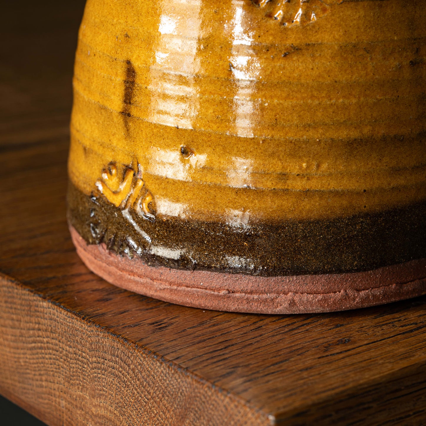 Close-up of Joshua Williams ochre glazed earthenware jug base