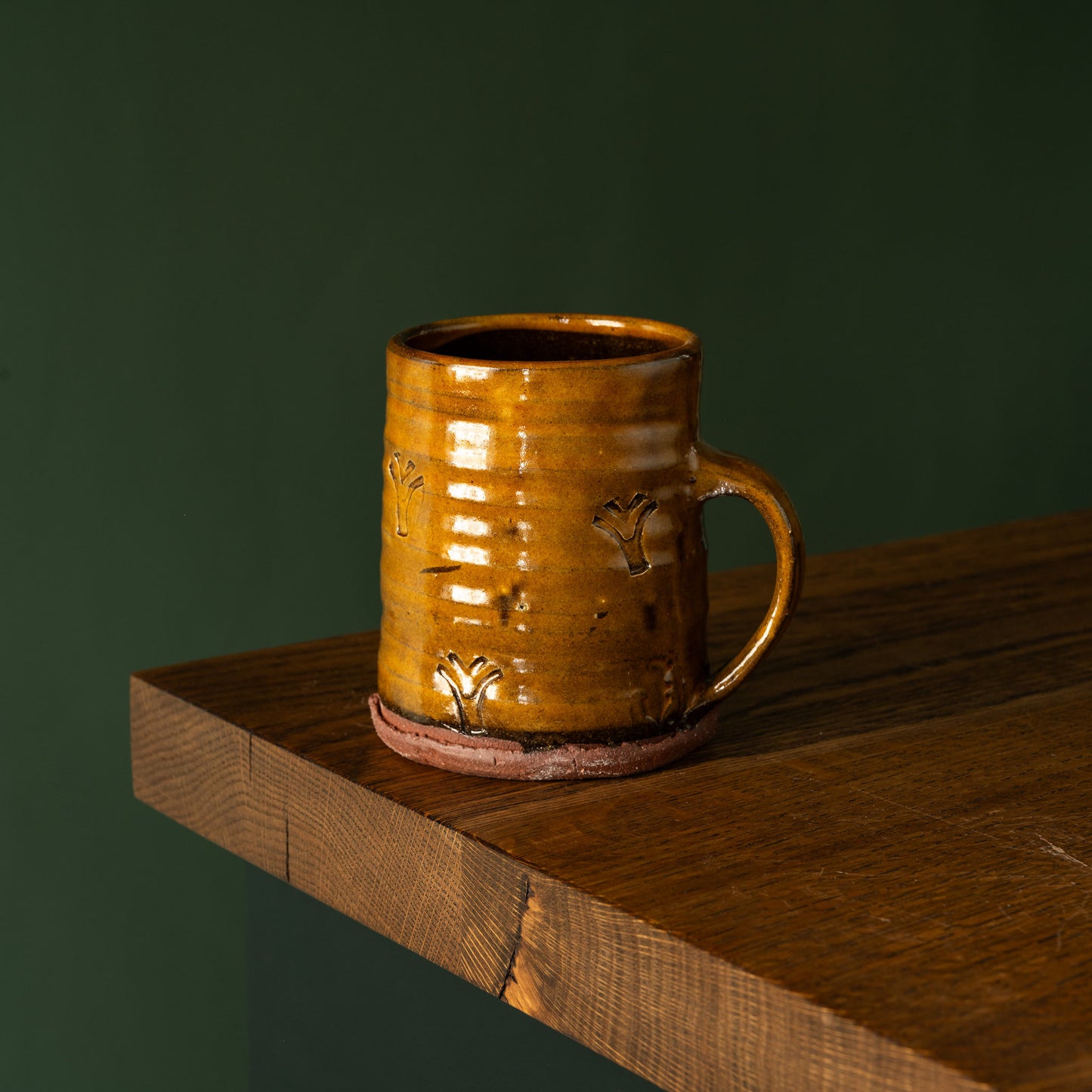 Joshua Williams ochre earthenware mug with embossed surface designs
