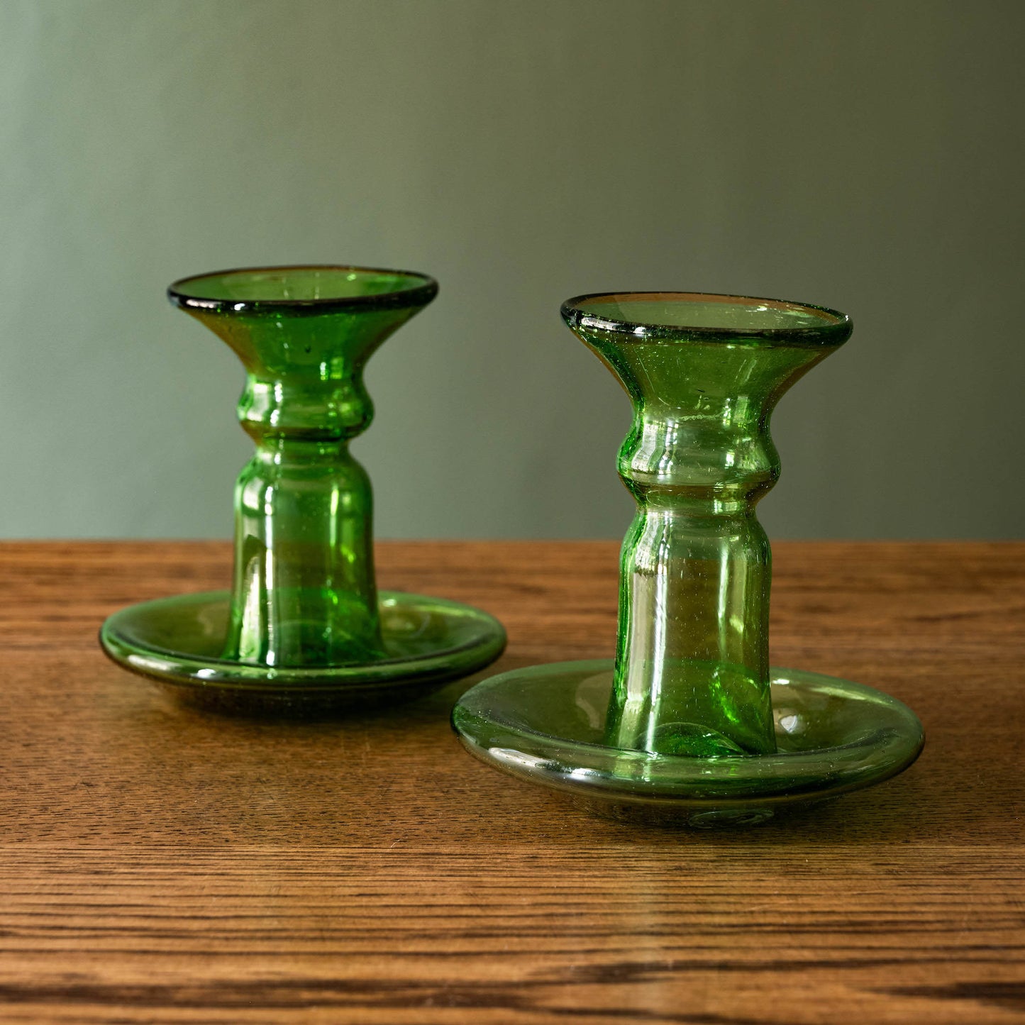 Pair of La Soufflerie small glass candlesticks in green.