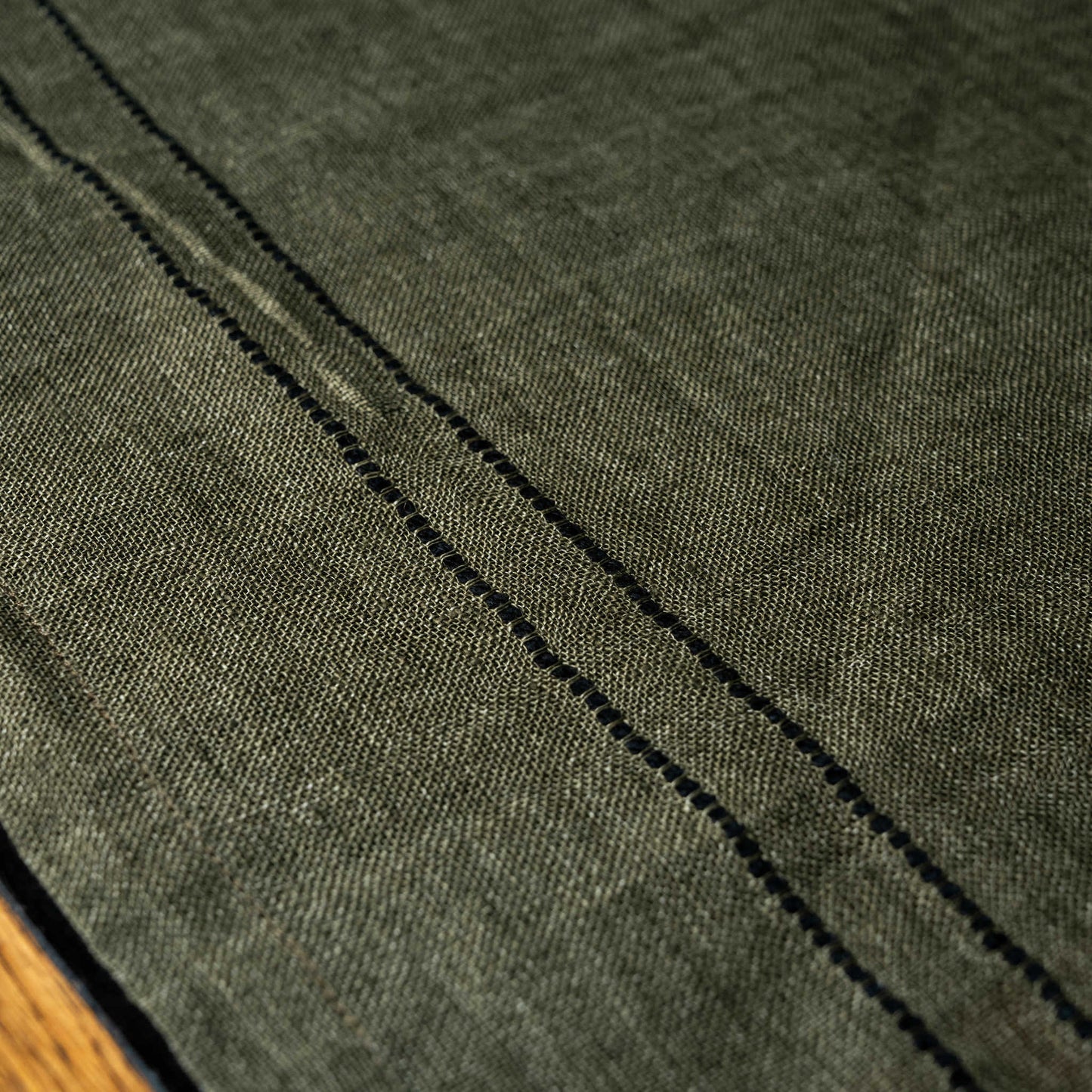 close up of Libeco Marie linen napkin showing washed linen and black stripes detail