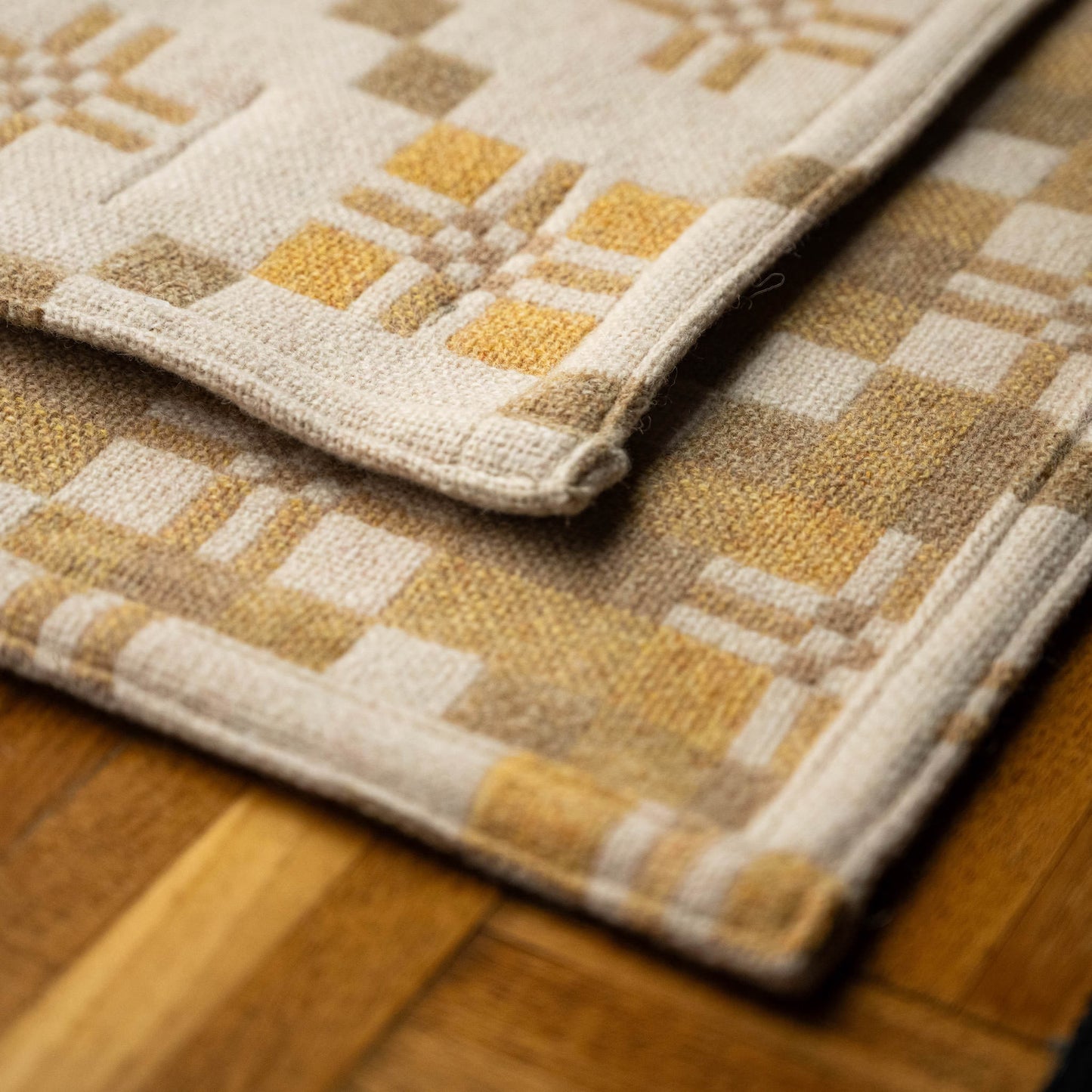 Hem & weave detail of Melin Tregwynt St Davids Cross Welsh Blanket in Traeth colourway.