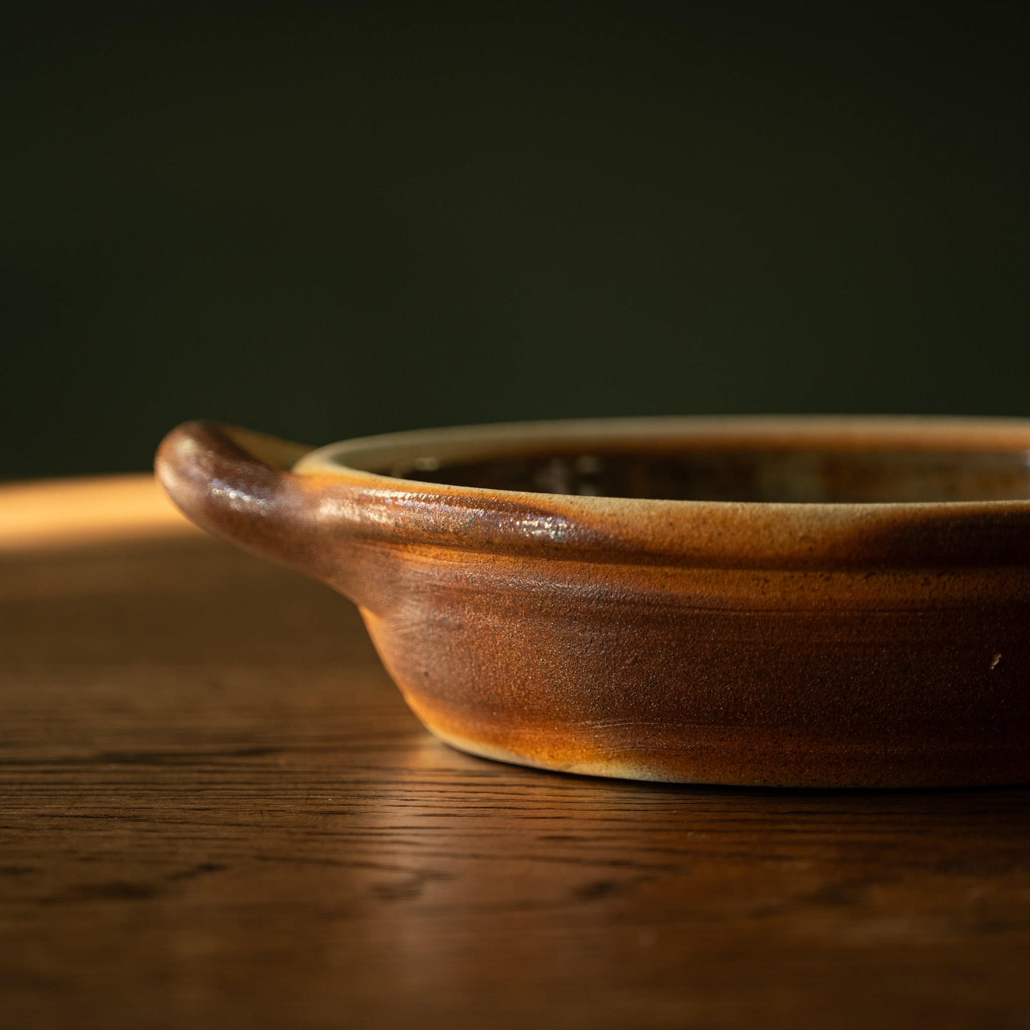 Muchelney Pottery small shallow baking dish side depth and handle.