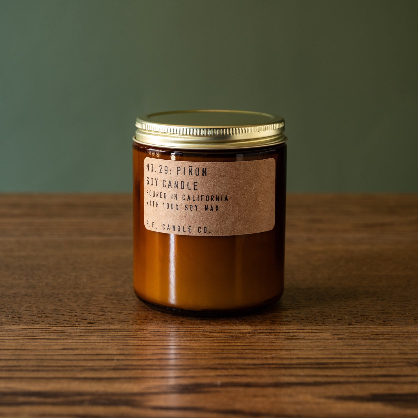 PF Candle Co Piñon soy wax candle in amber jar.