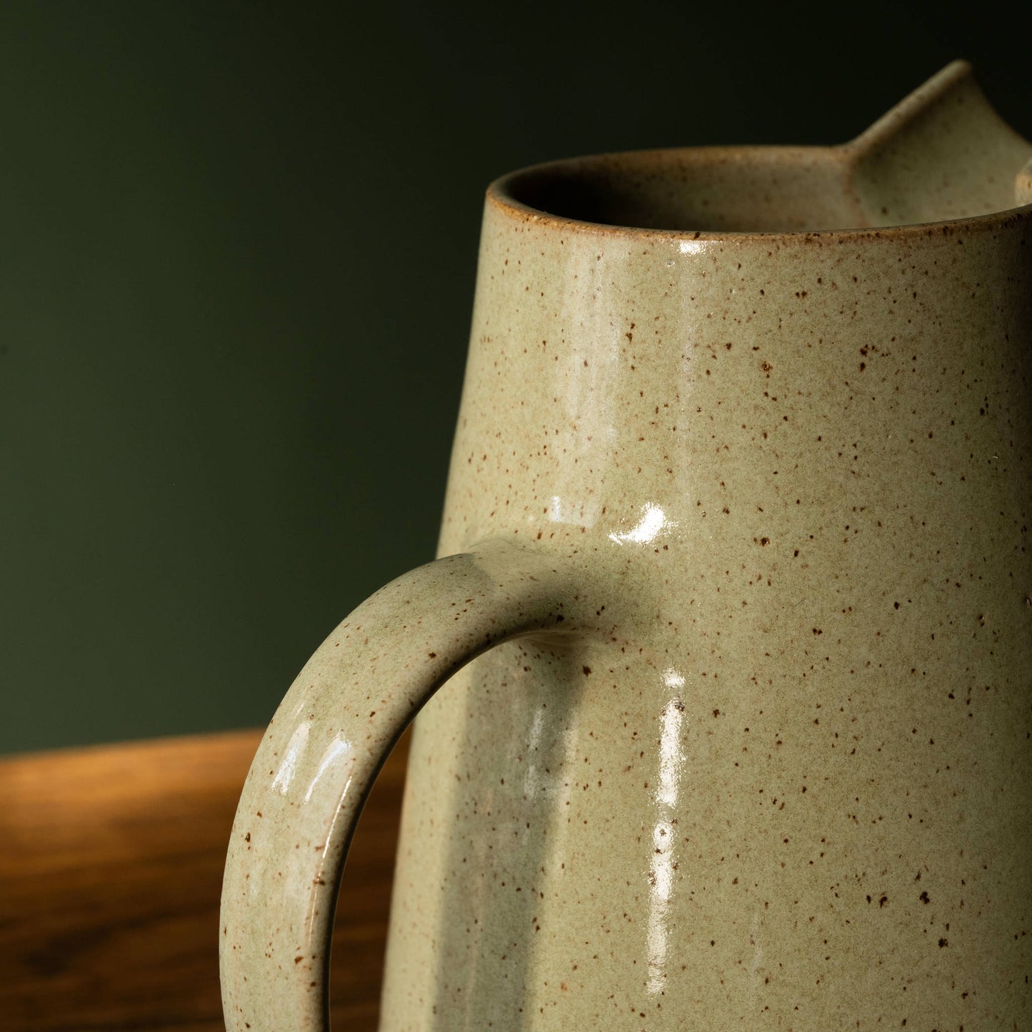 handle of Pottery West stoneware Jug in olive glaze.