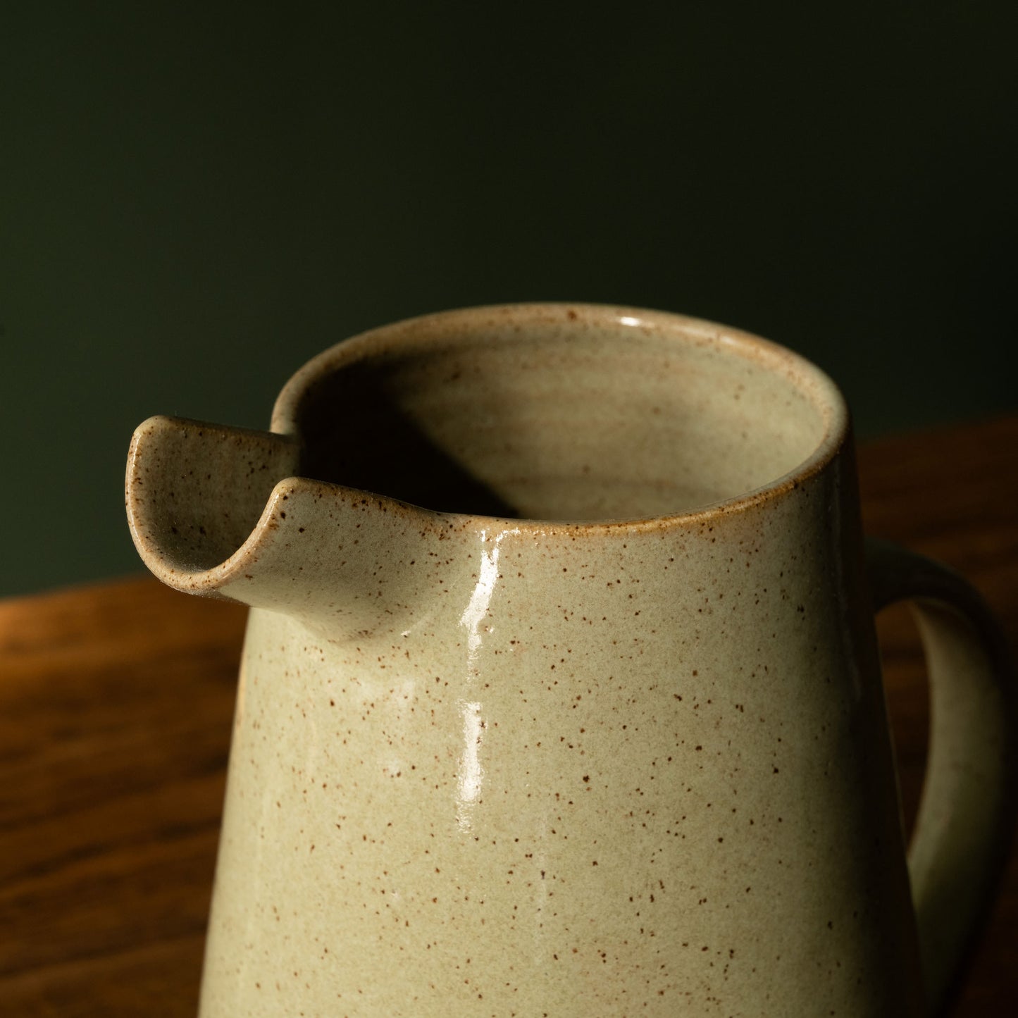 Spout of Pottery West stoneware jug in olive glaze.