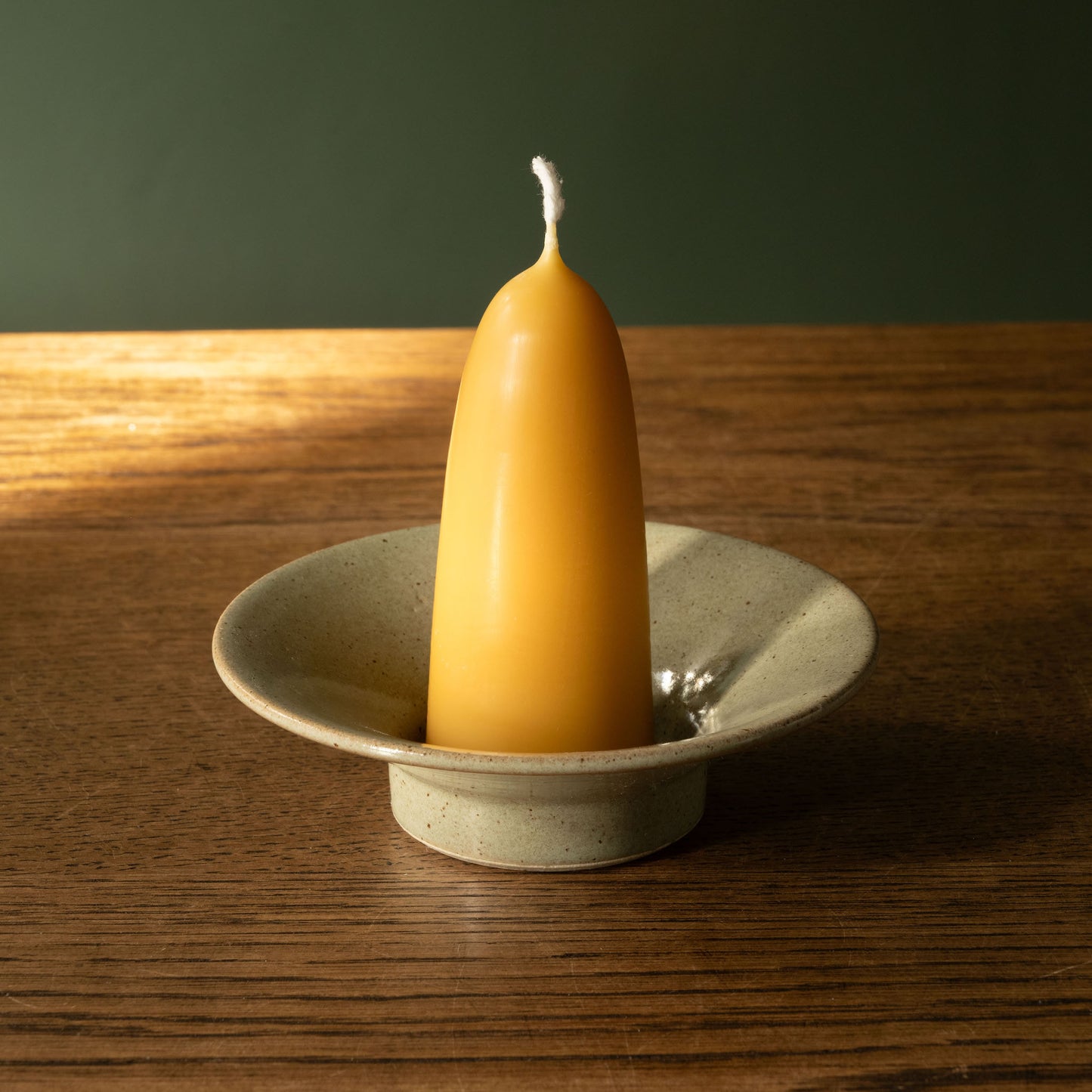 Pottery West Stoneware Stumpie Candle Holder in olive glaze with beeswax stumpie candle.