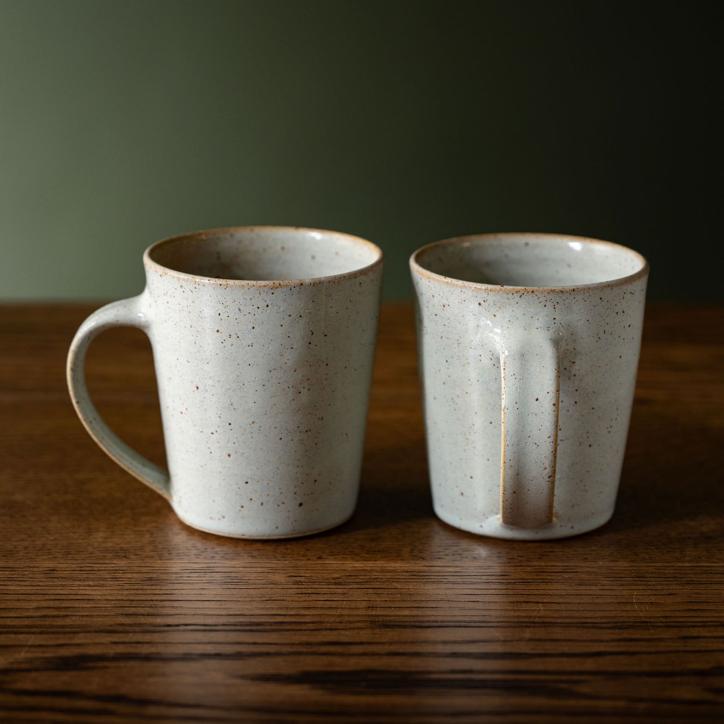 A pair of Pottery West powder blue tapered stoneware mugs