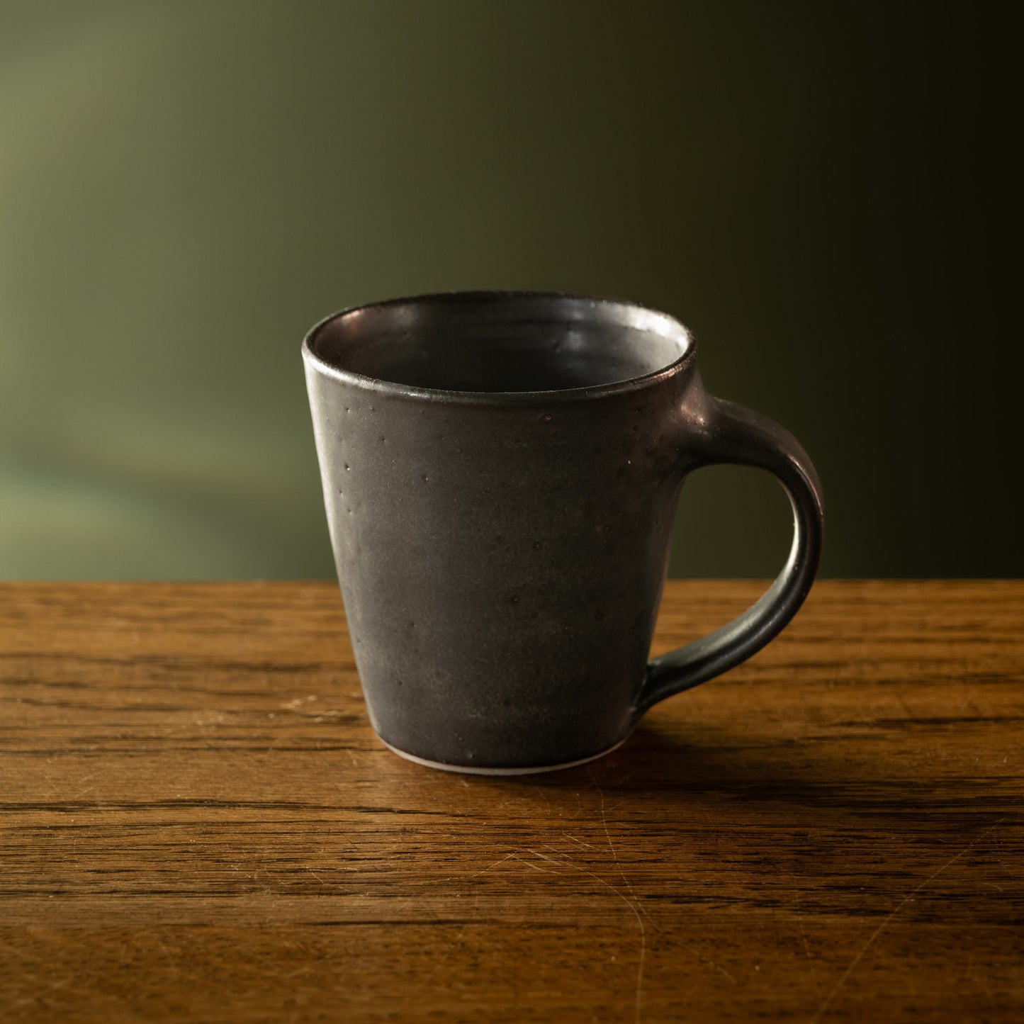 Pottery West wheel thrown espresso mug in charcoal glaze.