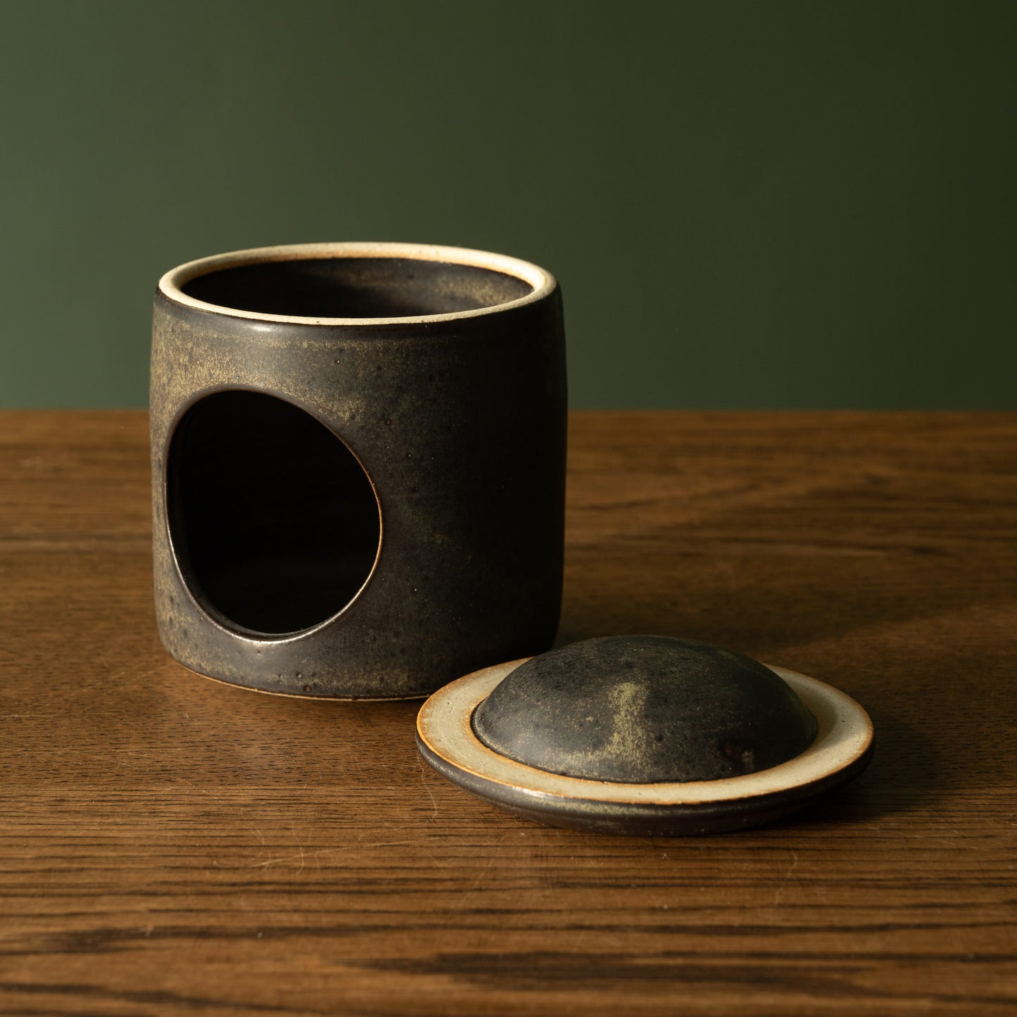 Pottery West stoneware oil warmer in charcoal glaze with lid off.
