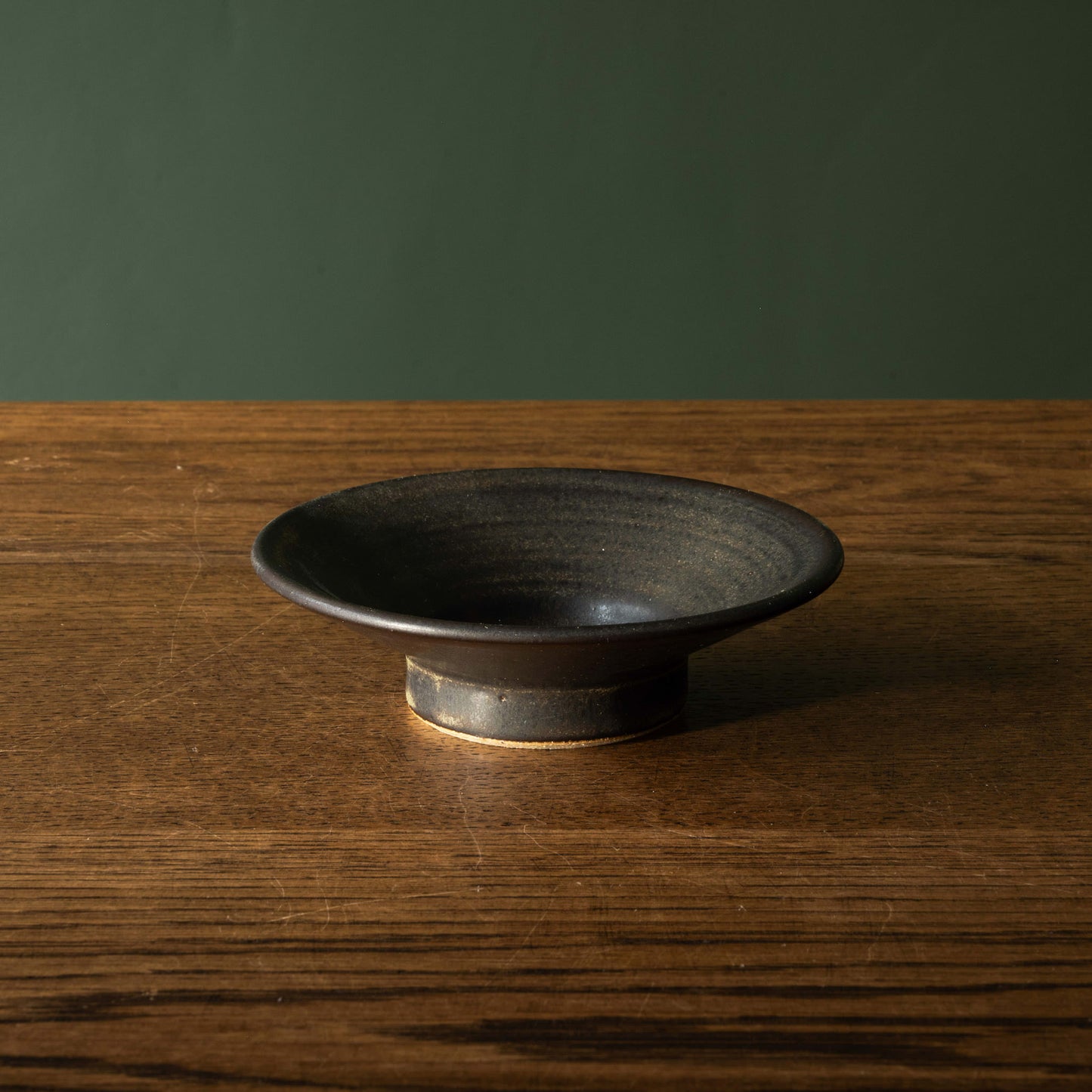Pottery West stoneware stumpie candle holder in charcoal glaze side view.