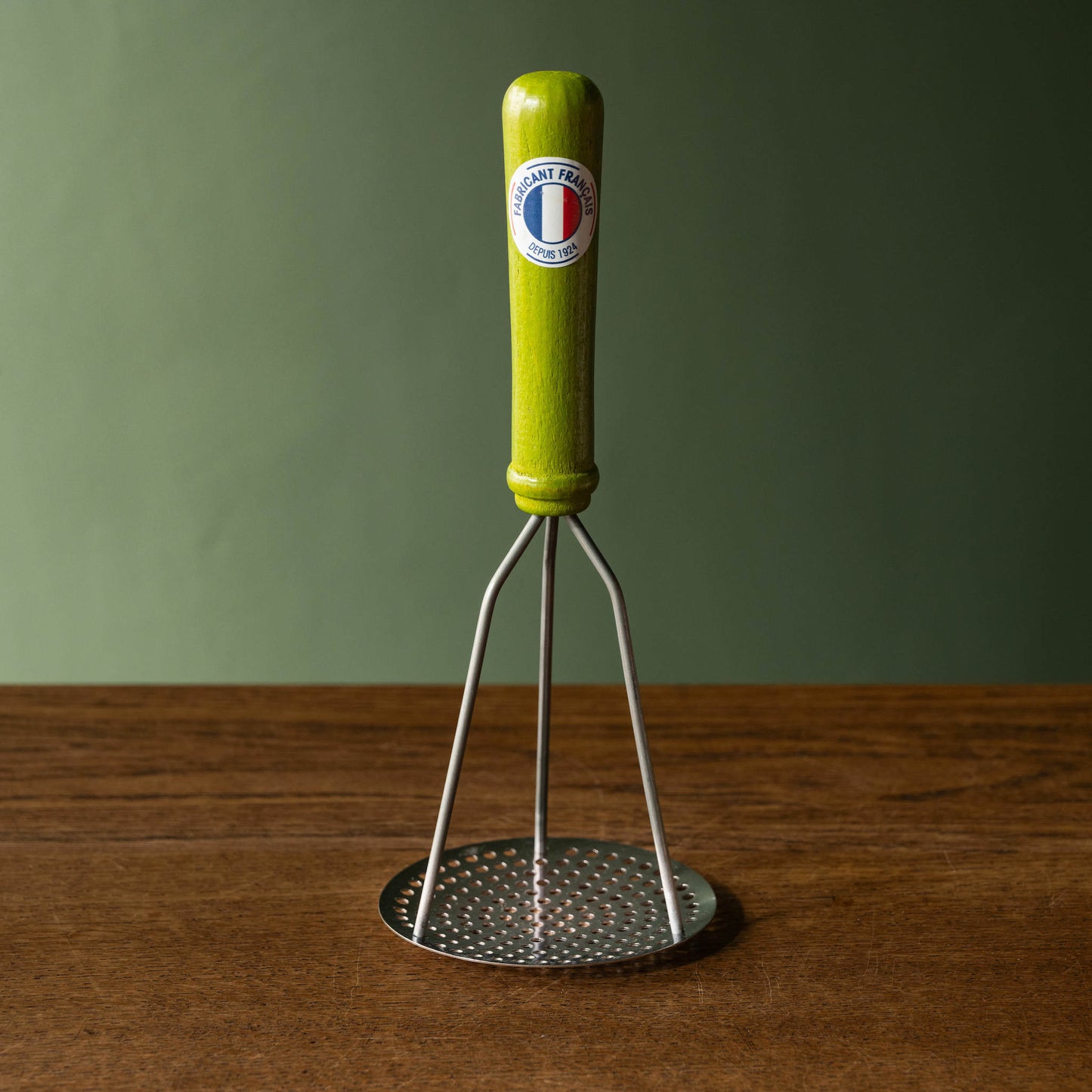 Roger Orfevre Potato Masher with lime green coloured wooden handle