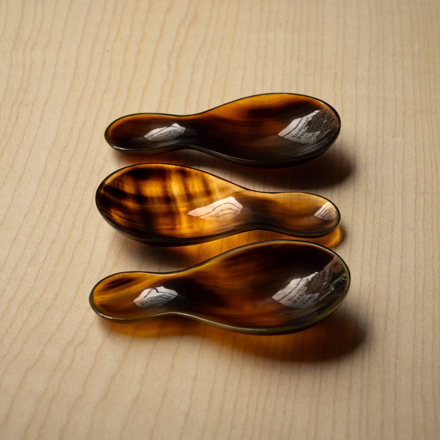 Assortment of Sarah Petherick Flame Horn Tea Caddy Spoons.