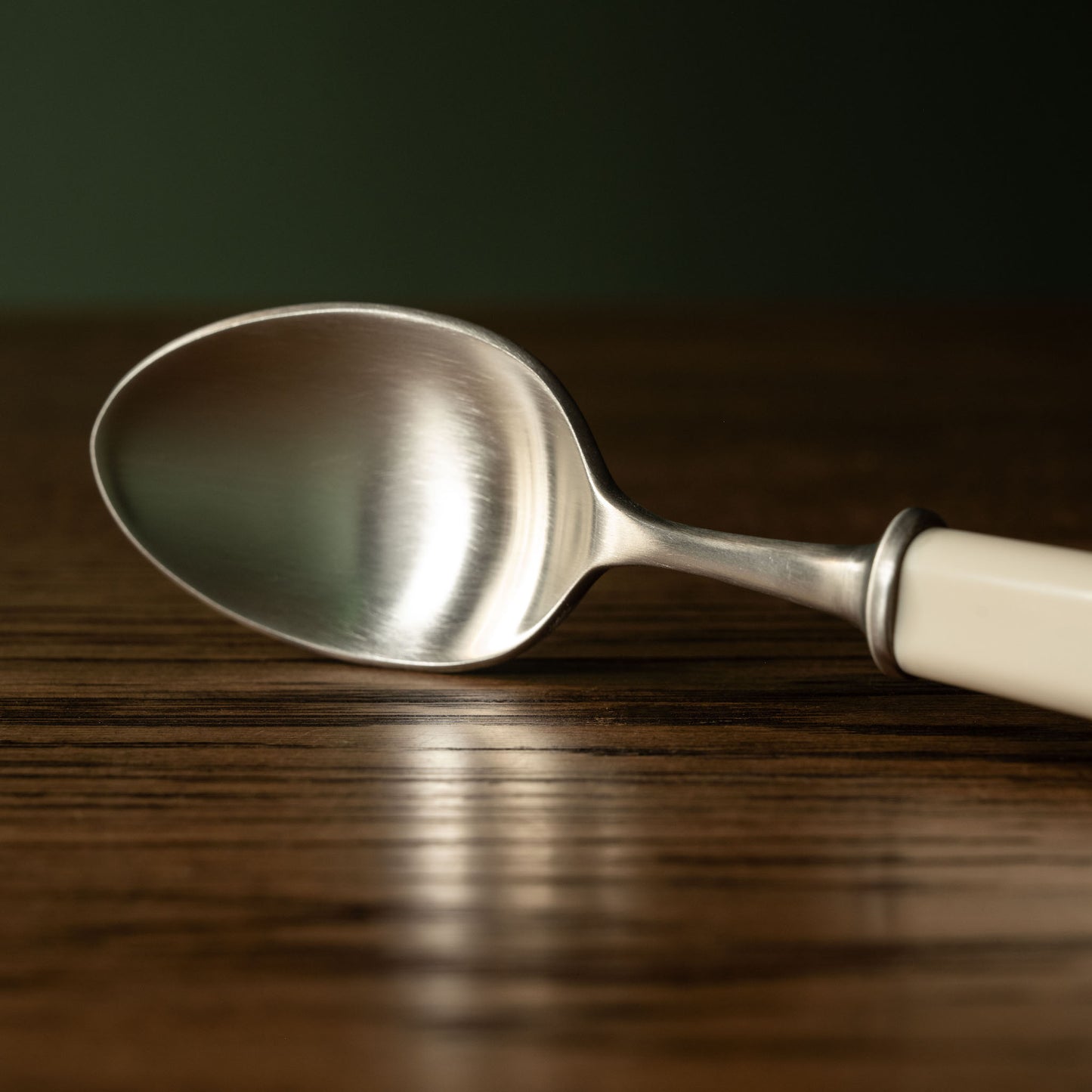 Tricketts of Sheffield Cream Handled Dessert Spoon close up