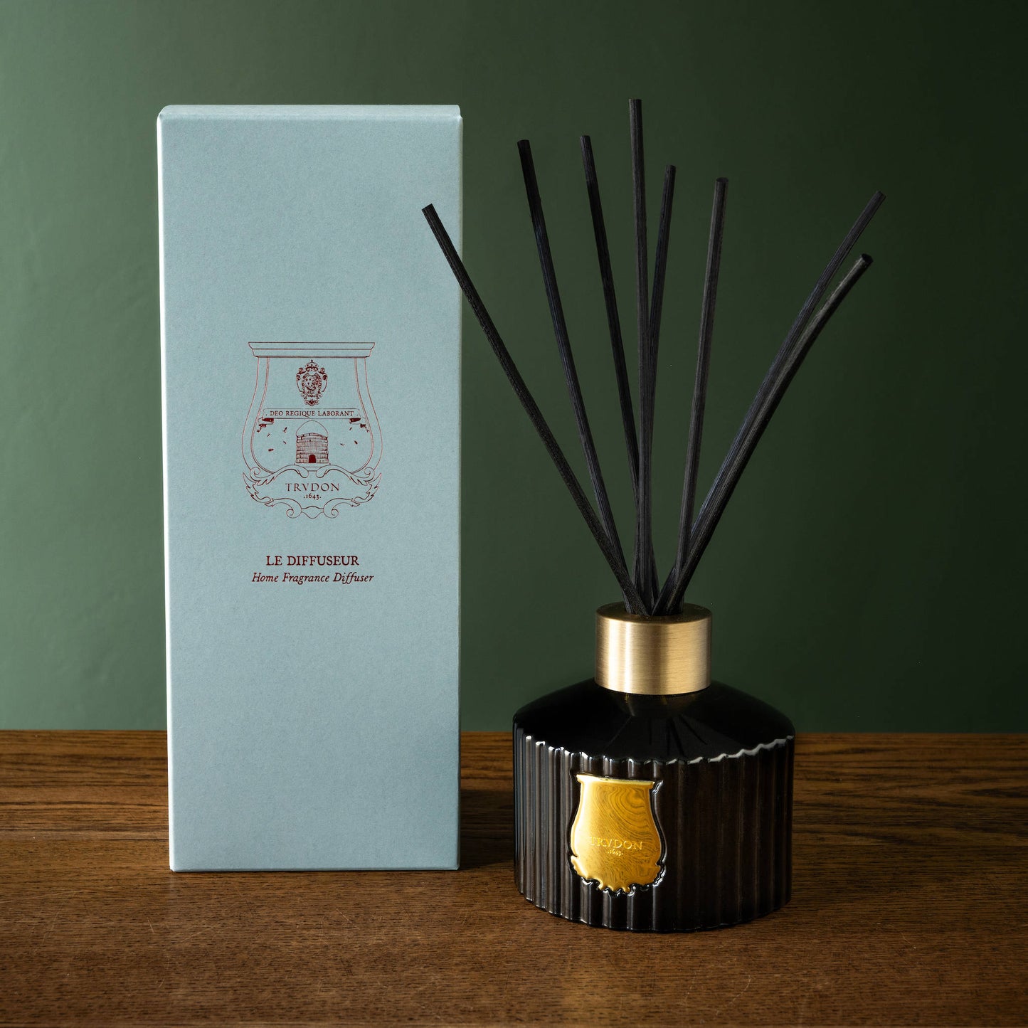 Trudon Gabriel Reed Diffuser next to its prerentation box on a wooden surface.