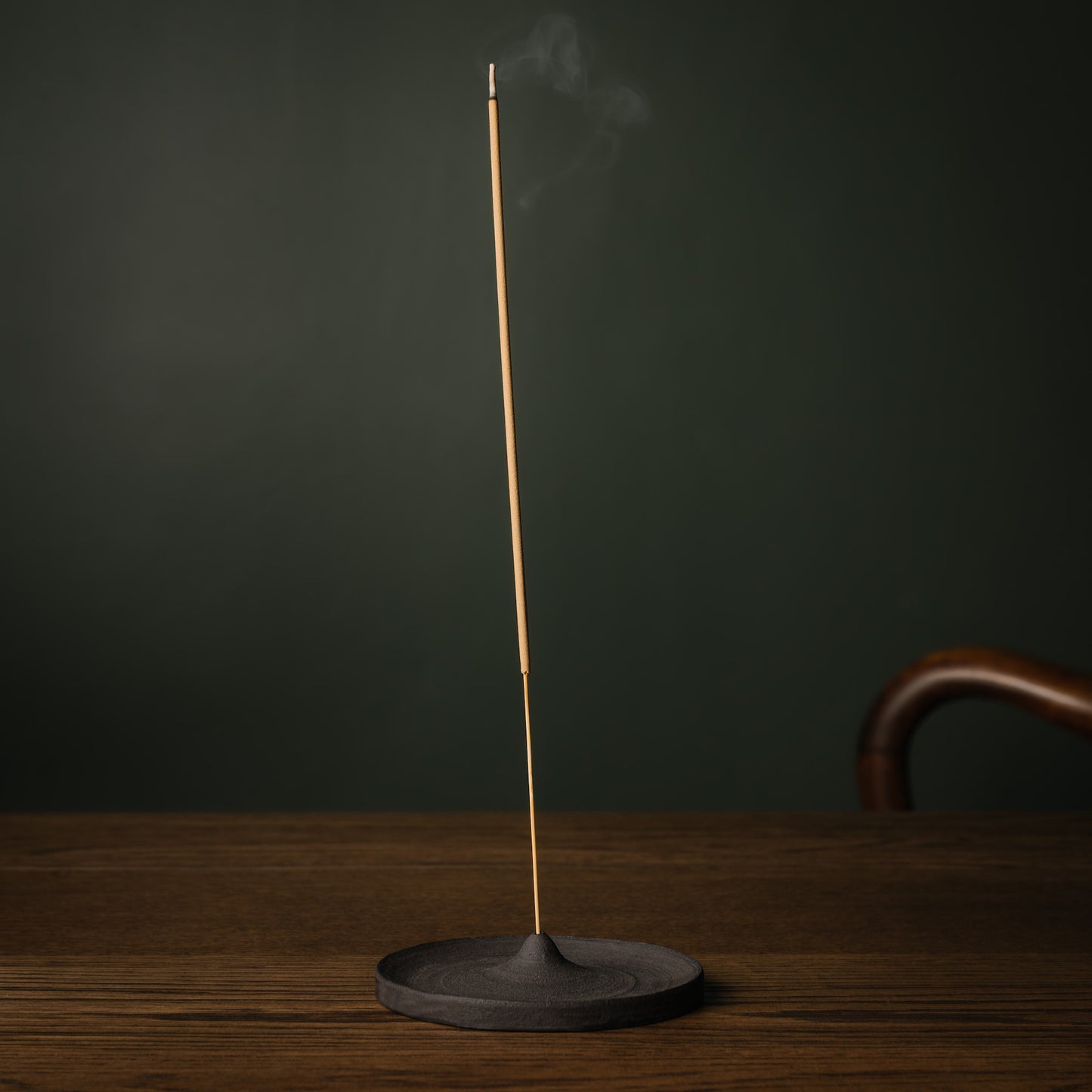 APFR Burbs incense stick burning in stoneware incense holder.