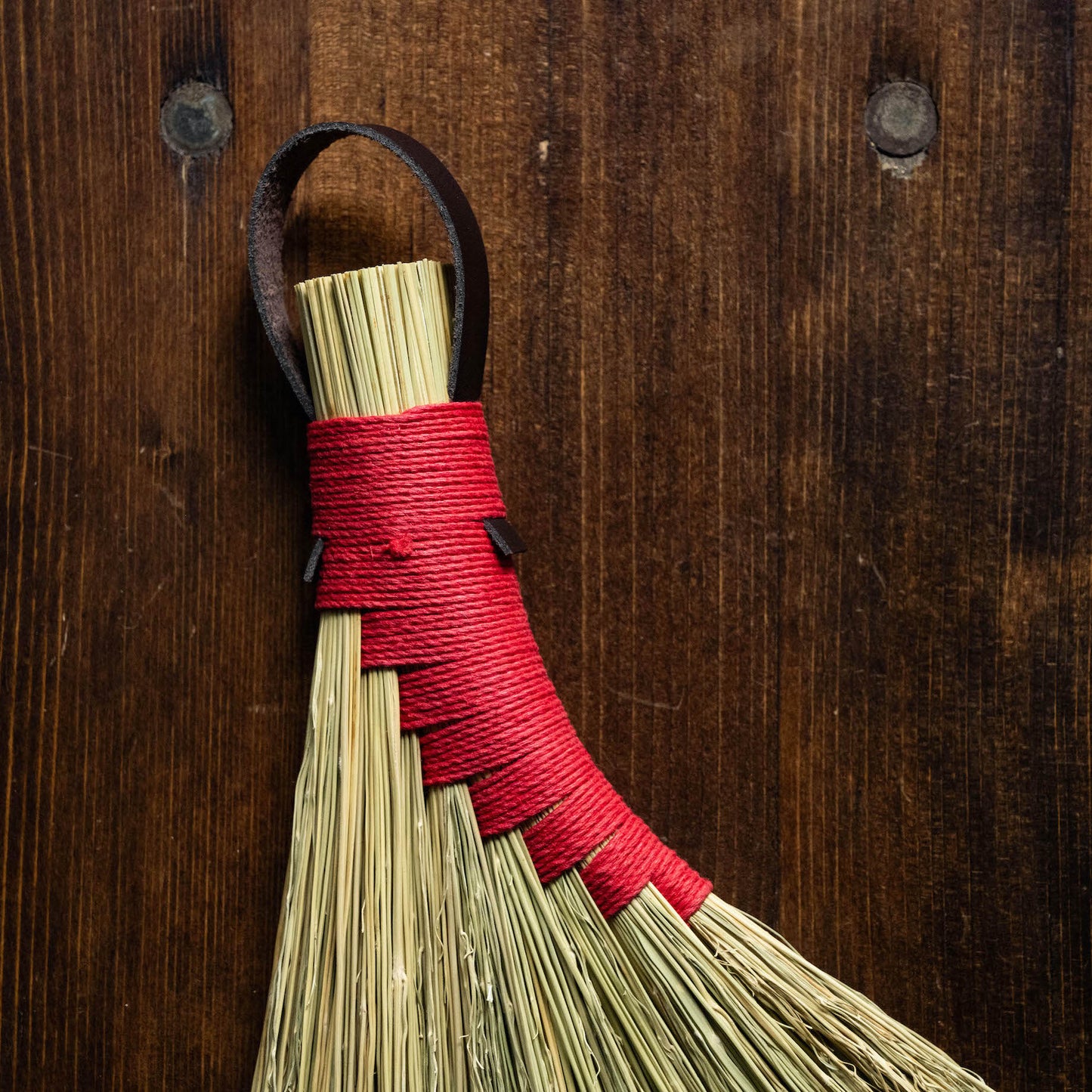 Close up of hemp binding of broomcorn hand broom. 