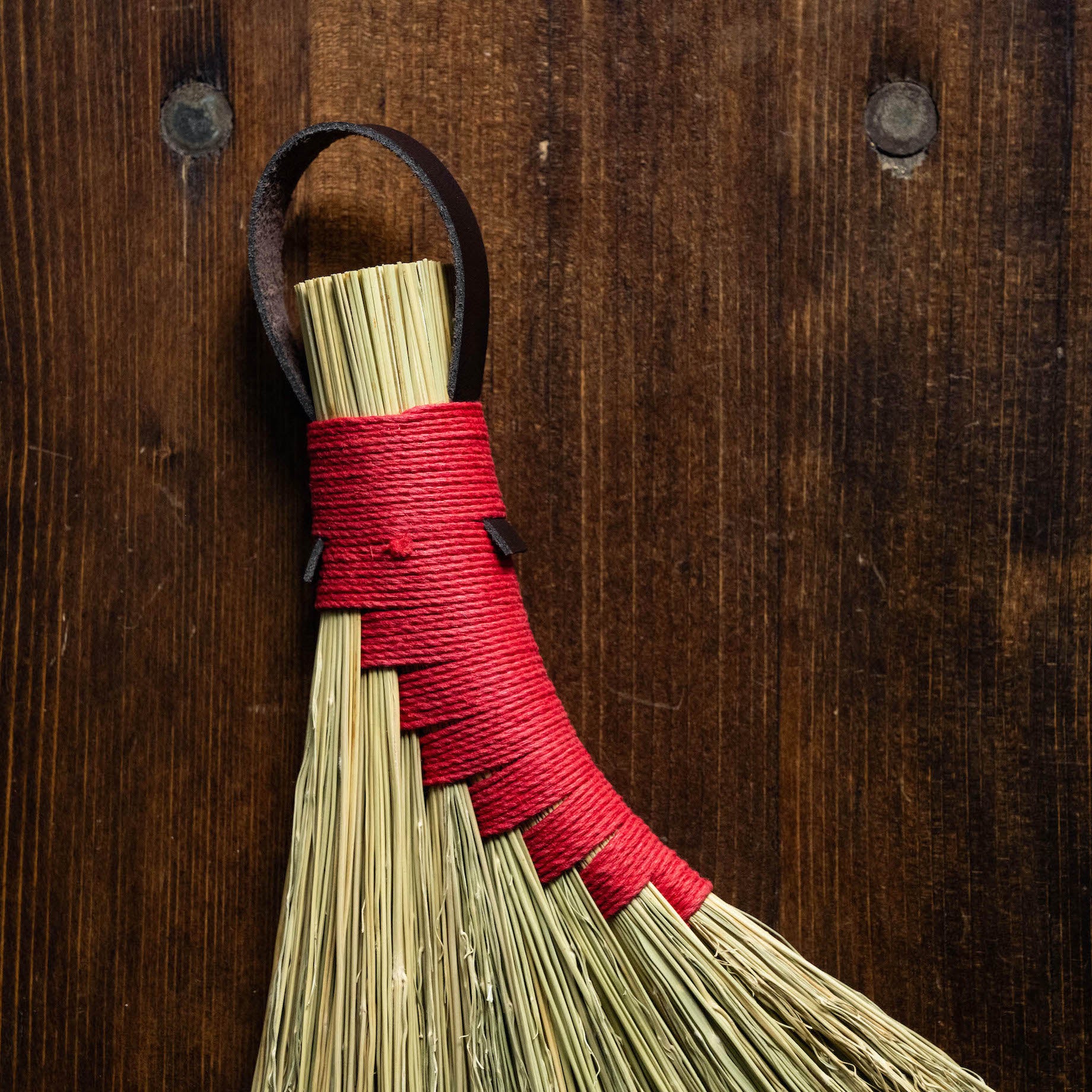 Close up of hemp binding of broomcorn hand broom. 