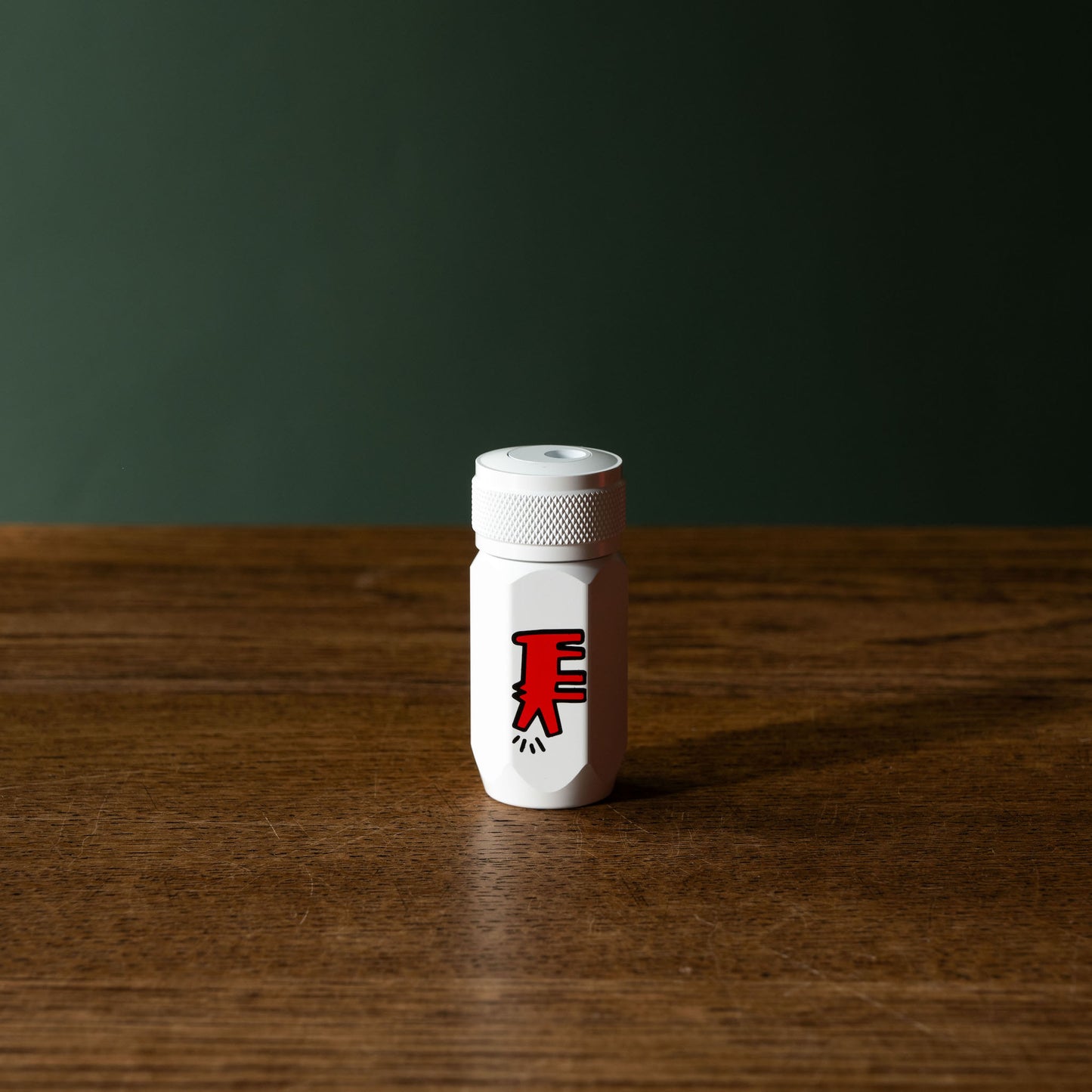 Blackwing Volume 292 Keith Haring "Dog" Long Point Sharpener. A white cylindrical design with red dog design.