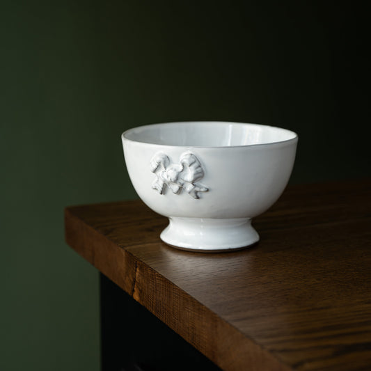 Carron Paris white Marie-Antoinette ceramic bowl with ribbon design on a wooden surface
