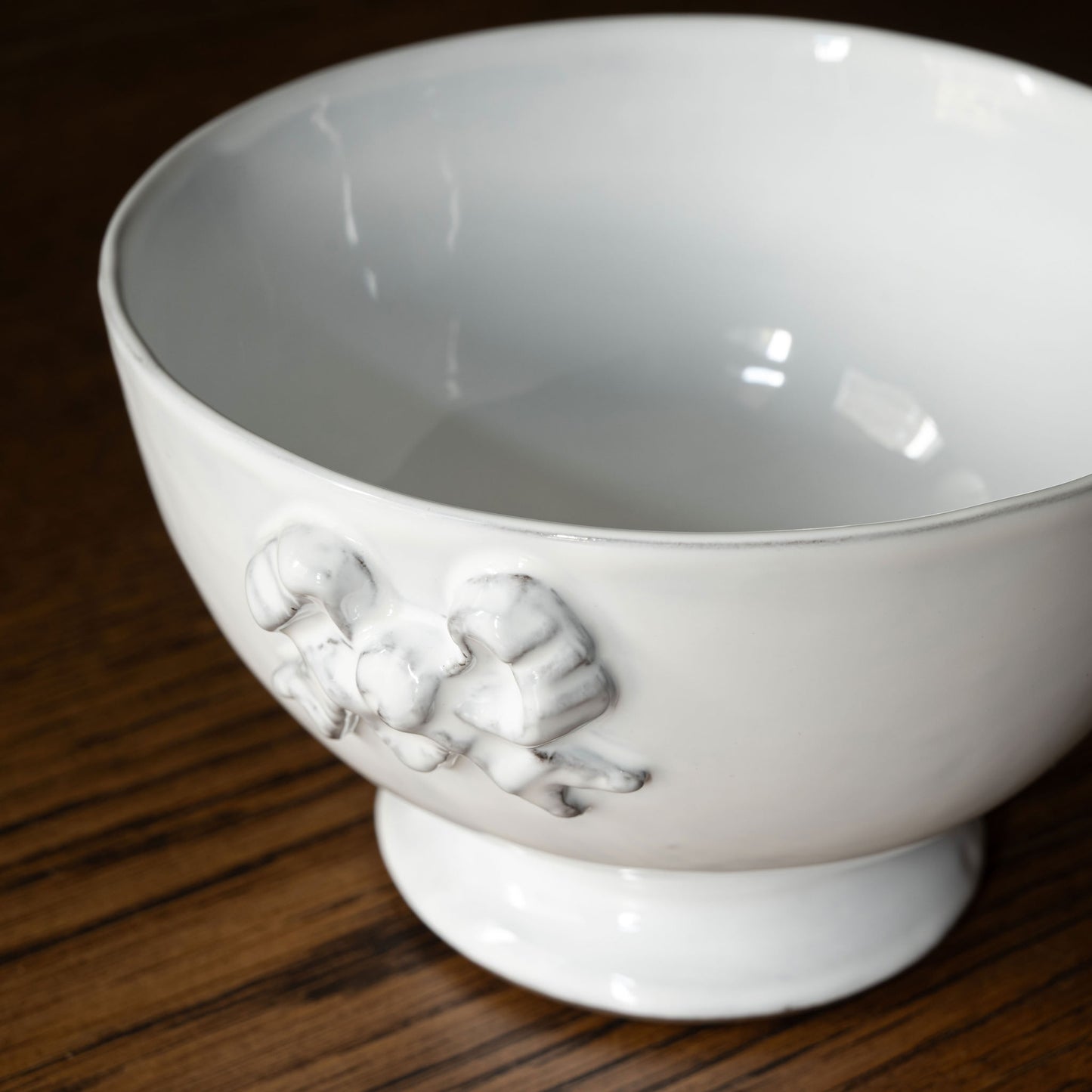 Carron Paris white Marie-Antoinette ceramic bowl with decorative ribbon design on a wooden surface