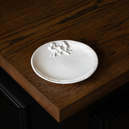 Carron Paris white Marie-Antoinette decorative plate with a ribbon design on a wooden surface