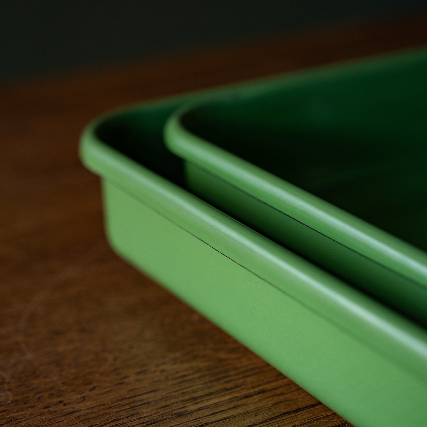 Side view of both square & rectangular green enamel baking trays