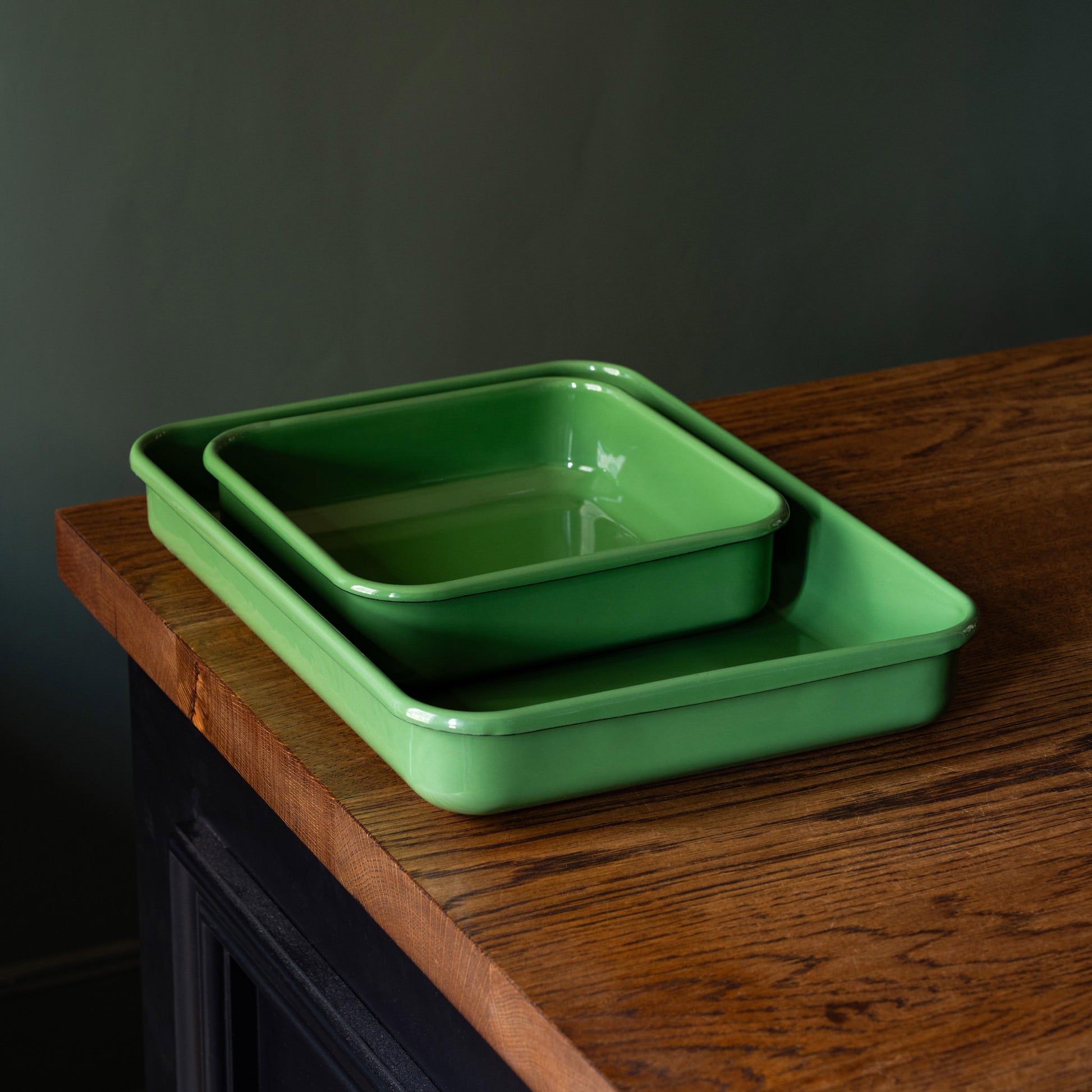 Rectangular & square green enamel trays nesting on worktop
