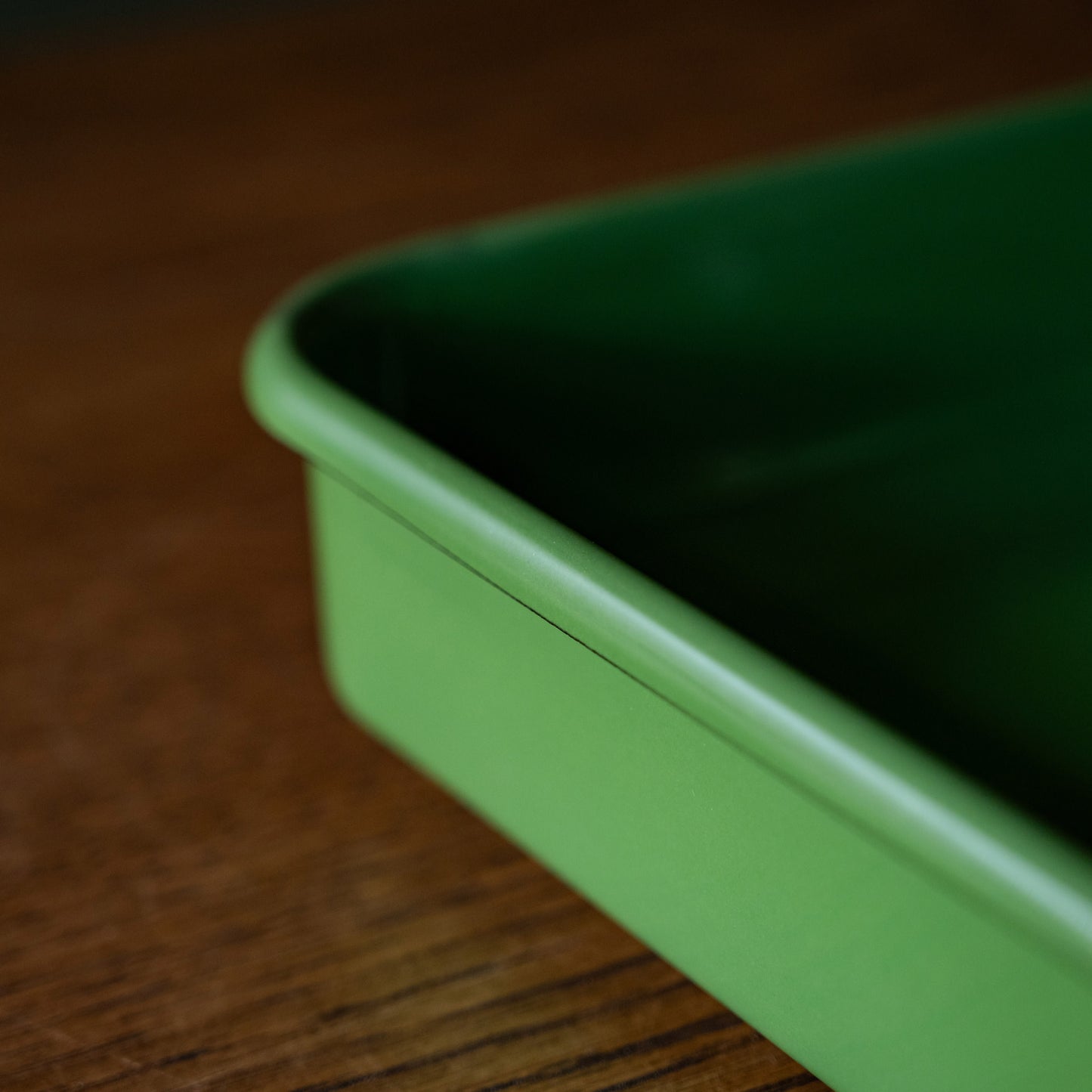 Side view of green enamel baking tray