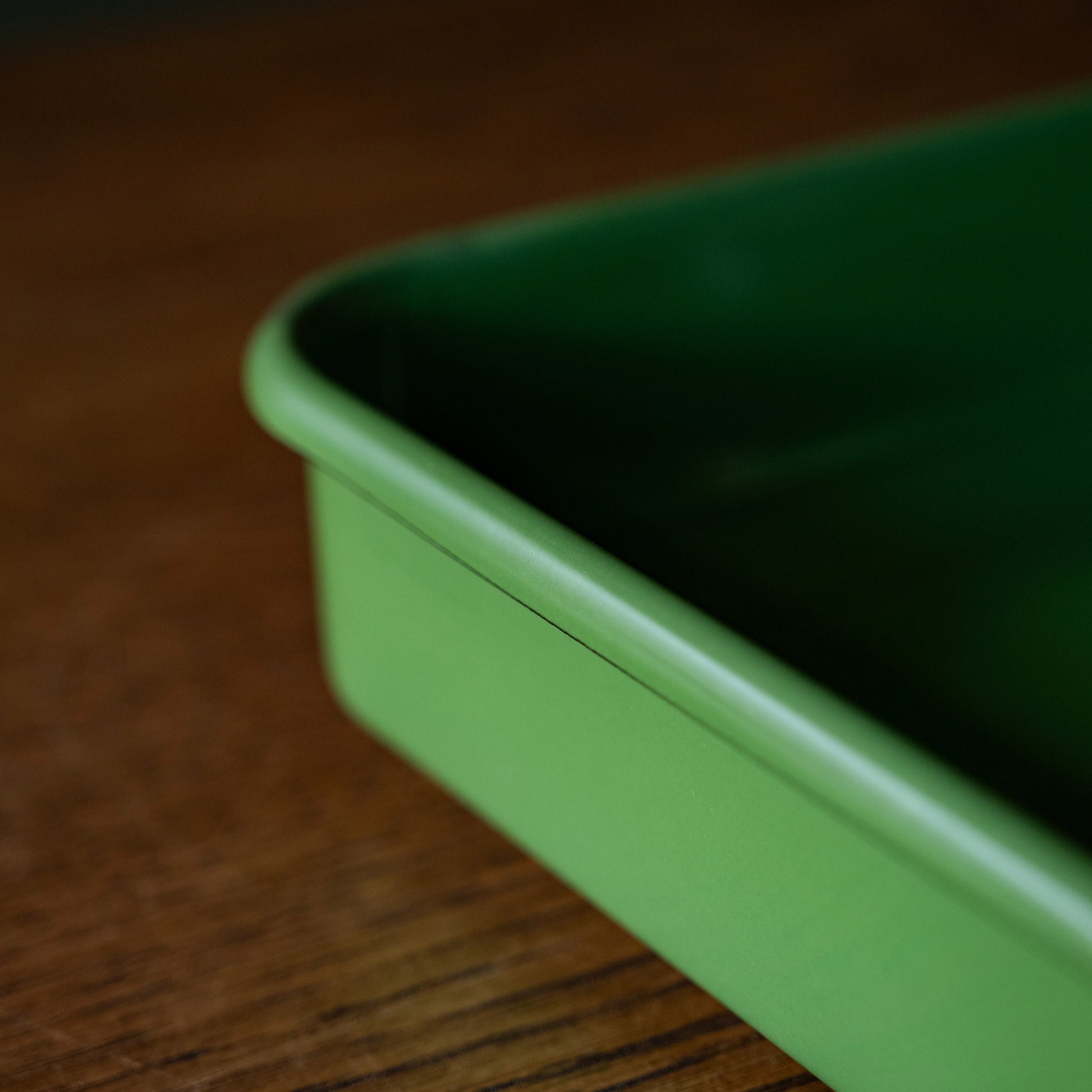 Side view of green enamel baking tray