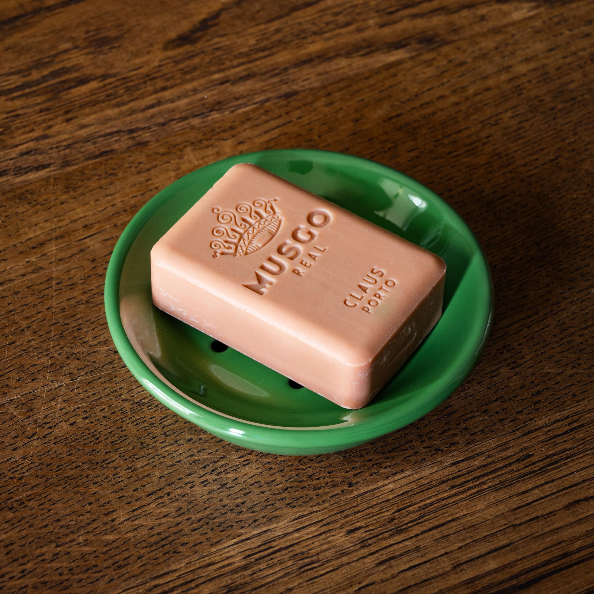 Musgo bar of soap on an enamel green soap dish 