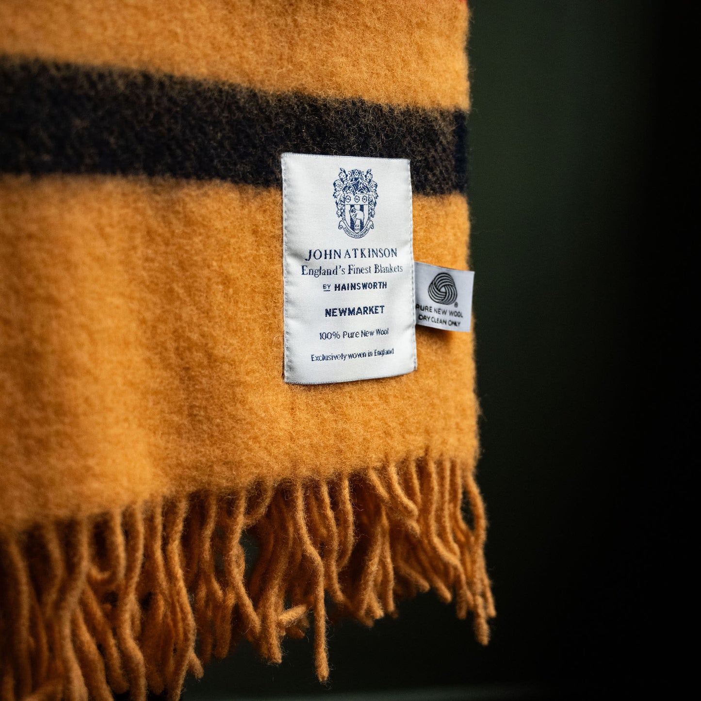 Care instructions and label of John Atkinson Newmarket Pure Wool Throw.