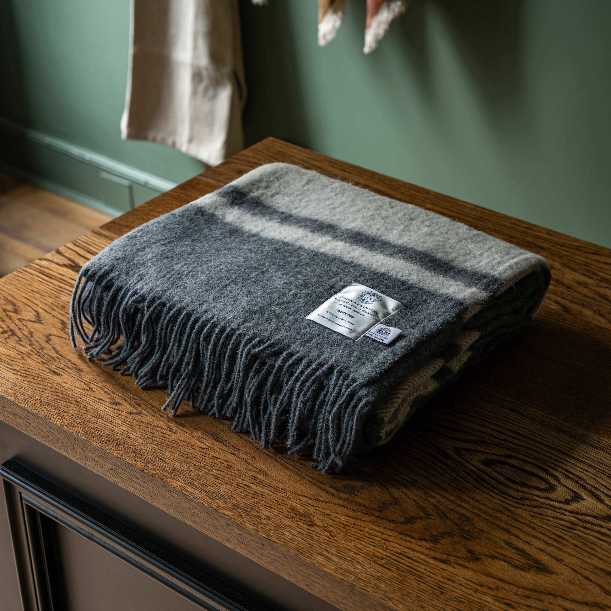Folded John Atkinson Winston wool blanket in grey with off-white stripes 