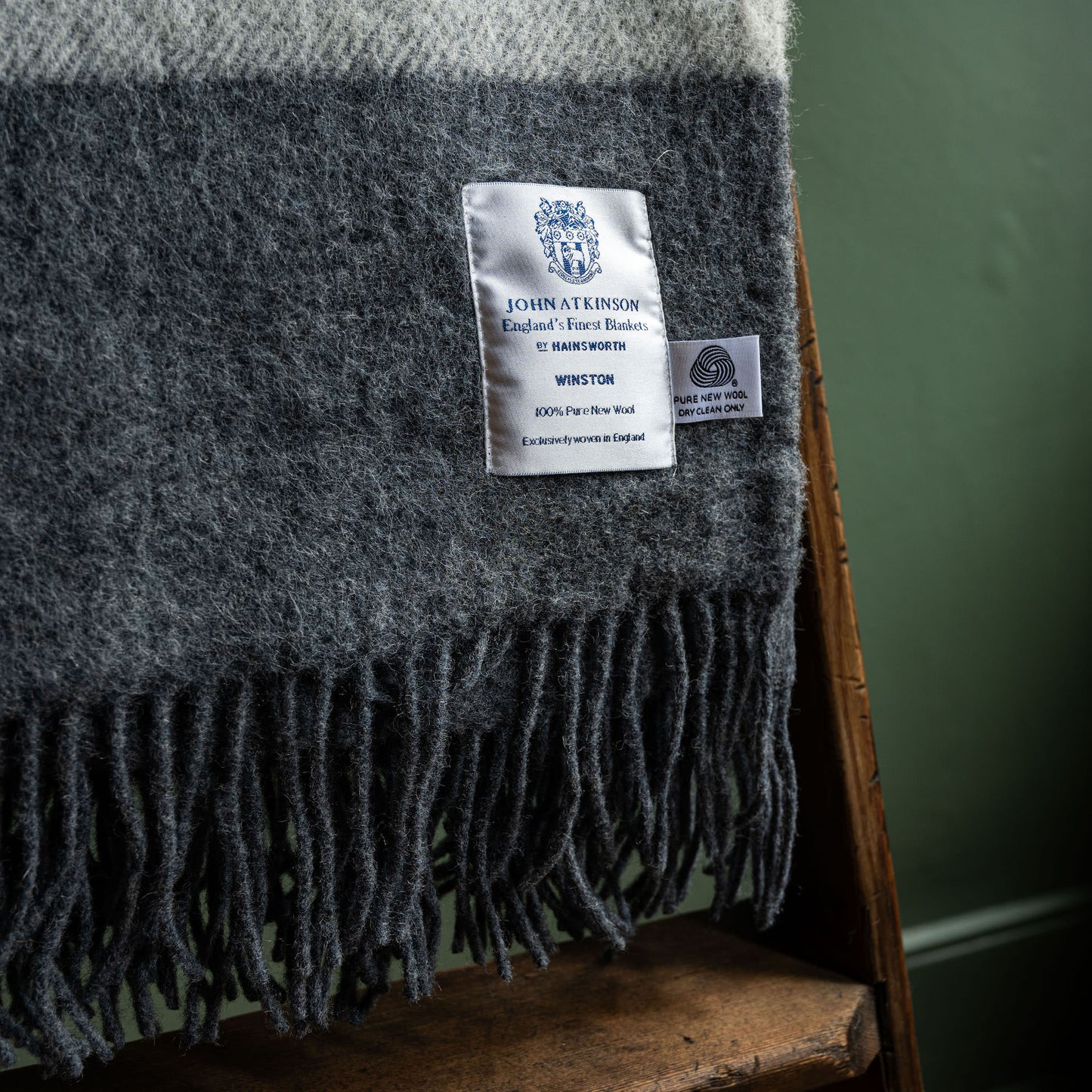 John Atkinson grey Winston blanket close up of woven label and fringes 