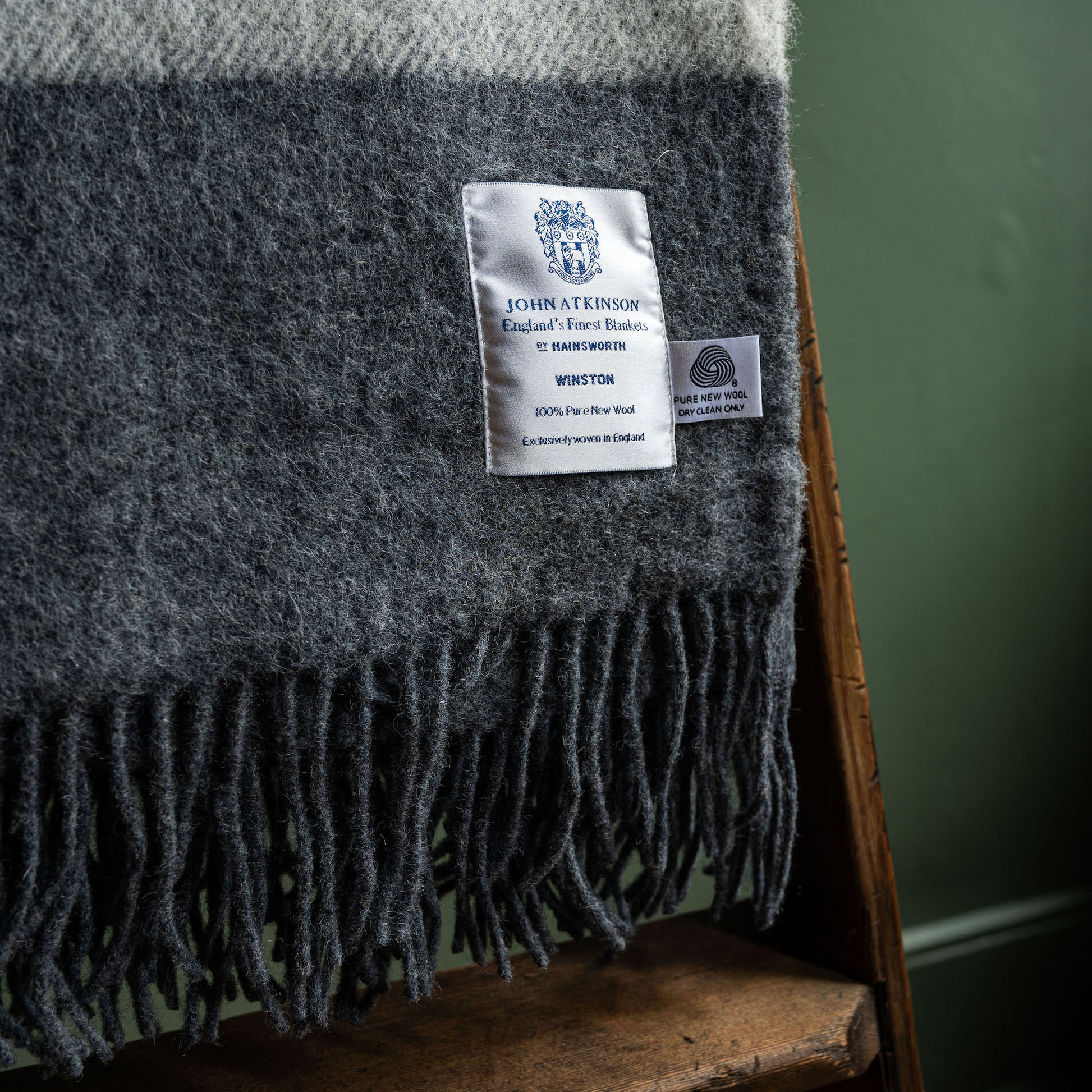 John Atkinson grey Winston blanket close up of woven label and fringes 