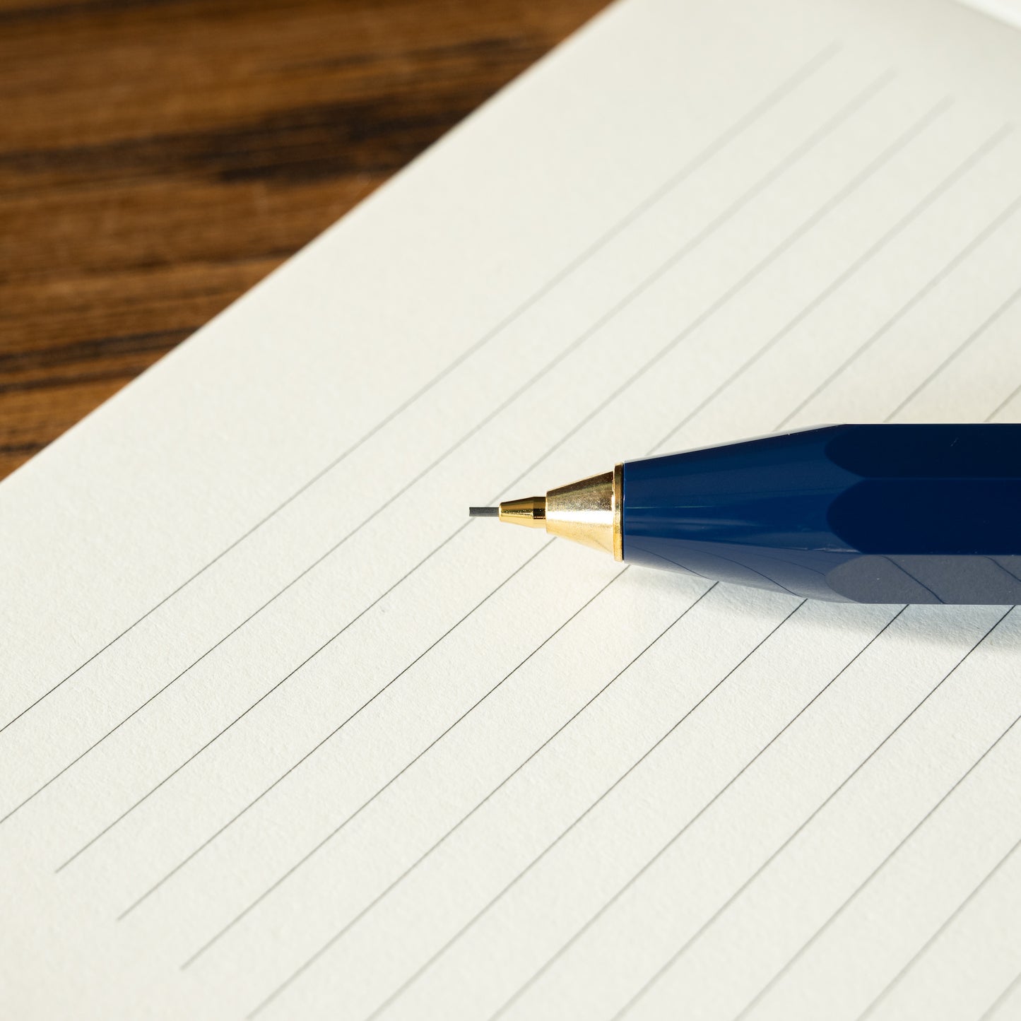 Kaweco Classic Sport blue mechanical pencil showing 0.7mm lead on a lined notebook page 