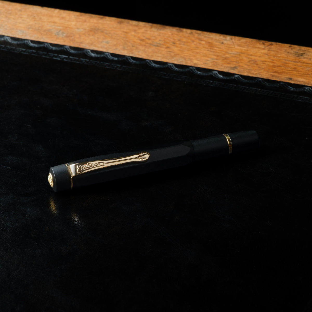 Kaweco Piston Sport AL fountain pen in black with gold trim with the lid closed. 