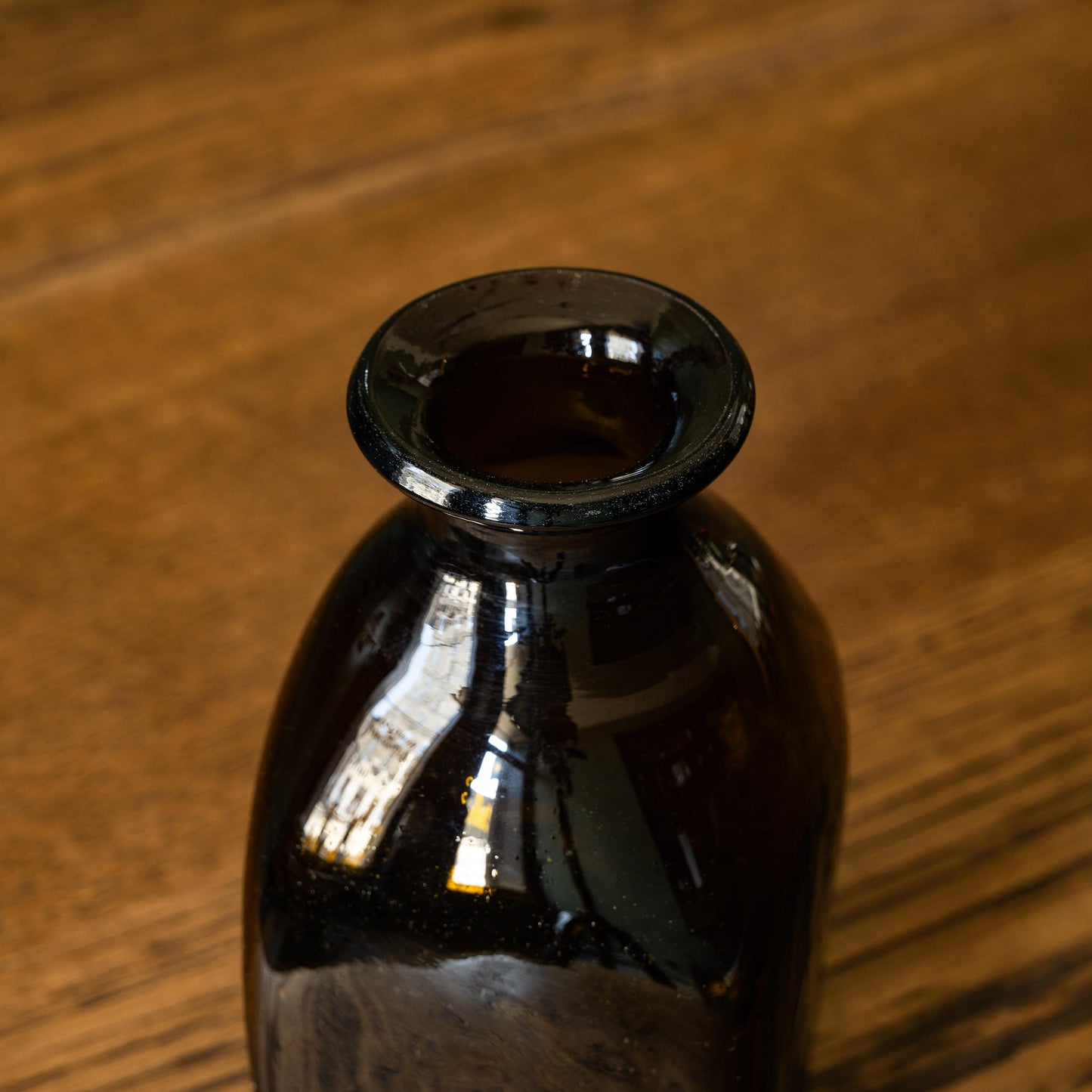 Neck and opening aperture of La Soufflerie Bouteille Carre Petit. A beautiful and versatile dark brown free blown glass bottle.  