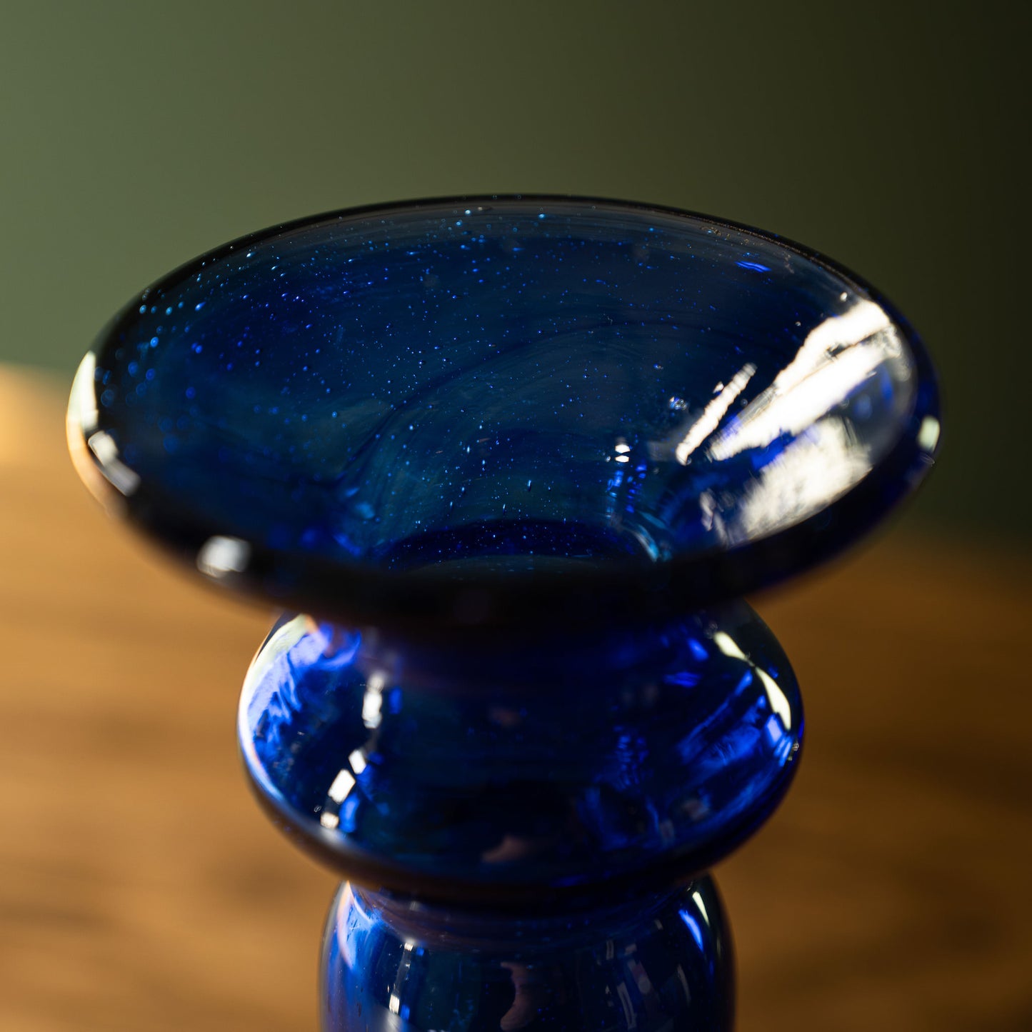 Neck of blue recycled glass candlestick by La Soufflerie. 
