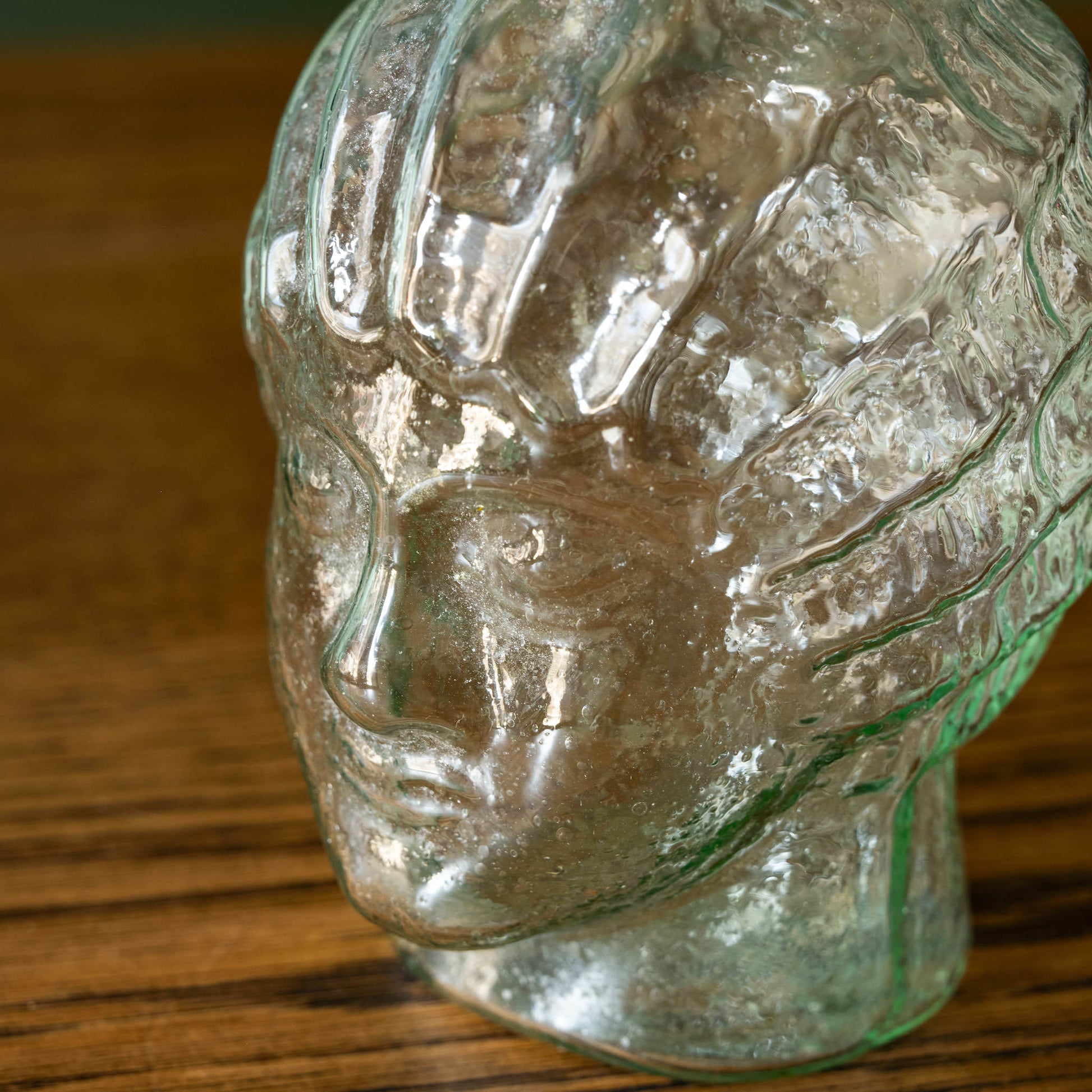 Close up of moulded face detail of La Soufflerie Liberté recycled glass vase. Inspired by Lady Liberty. 