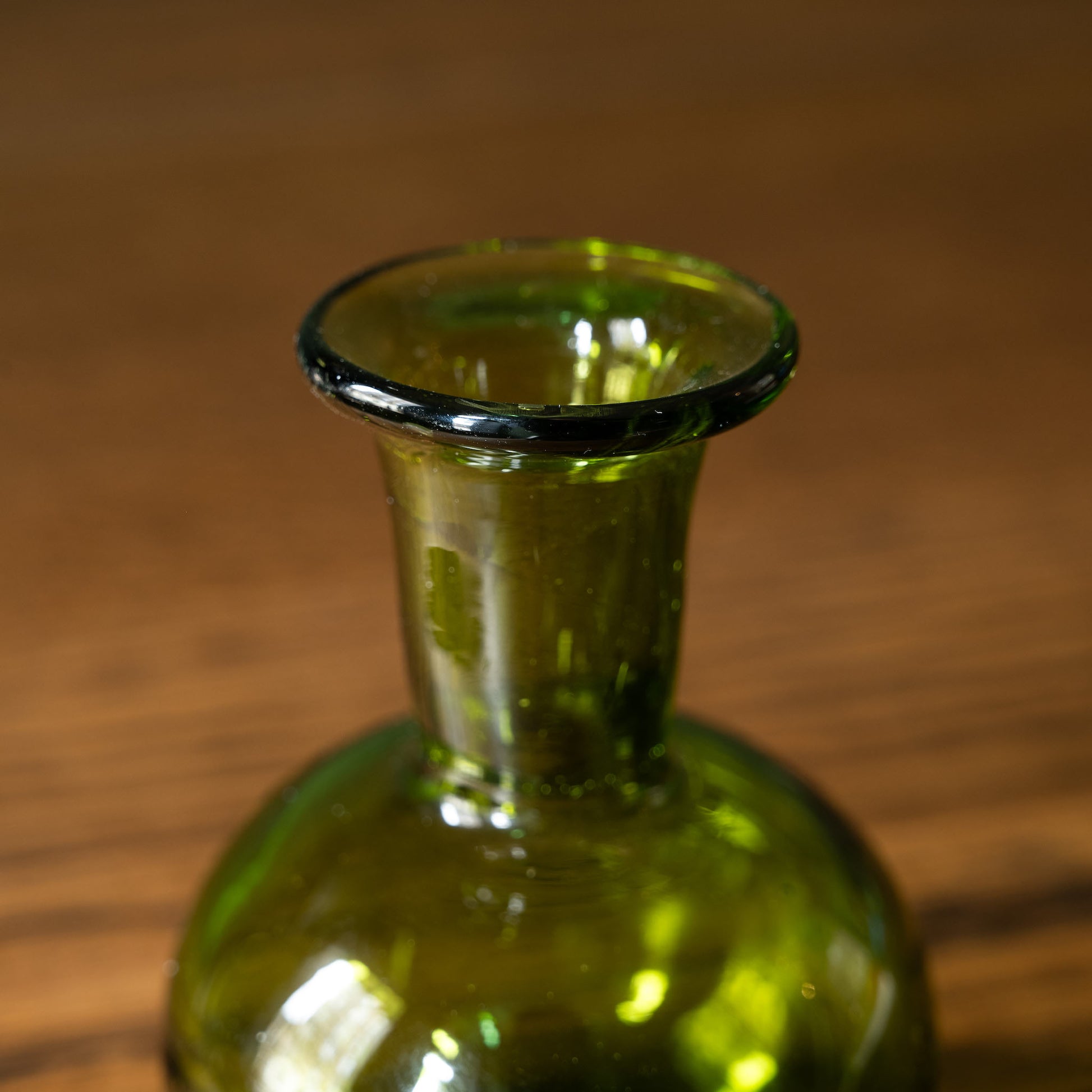 Close up of neck of La Soufflerie small green glass bud vase 